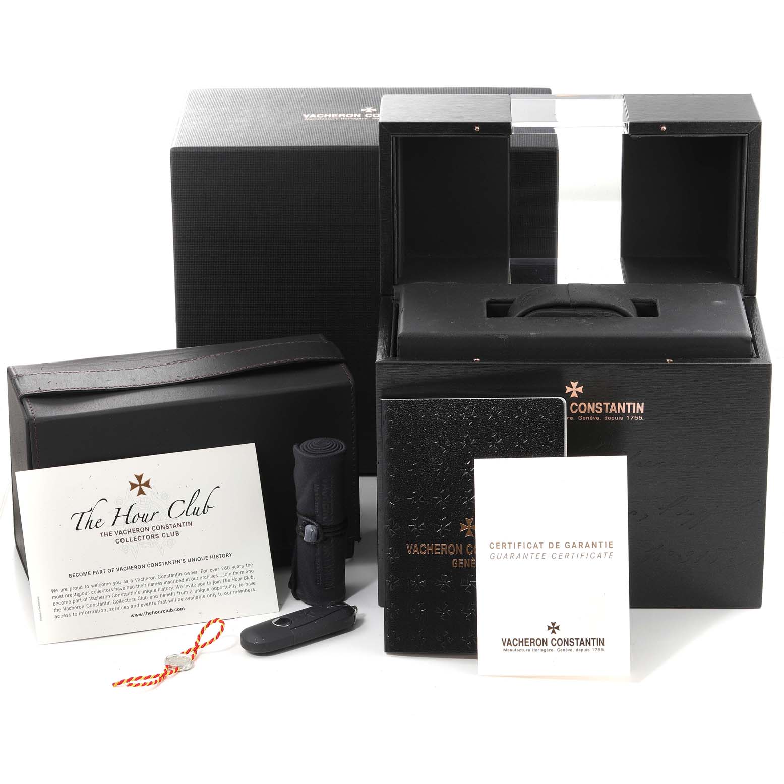 The image shows a Vacheron Constantin Vintage watch packaging, including an open box, documents, a watch holder, and watch accessories.