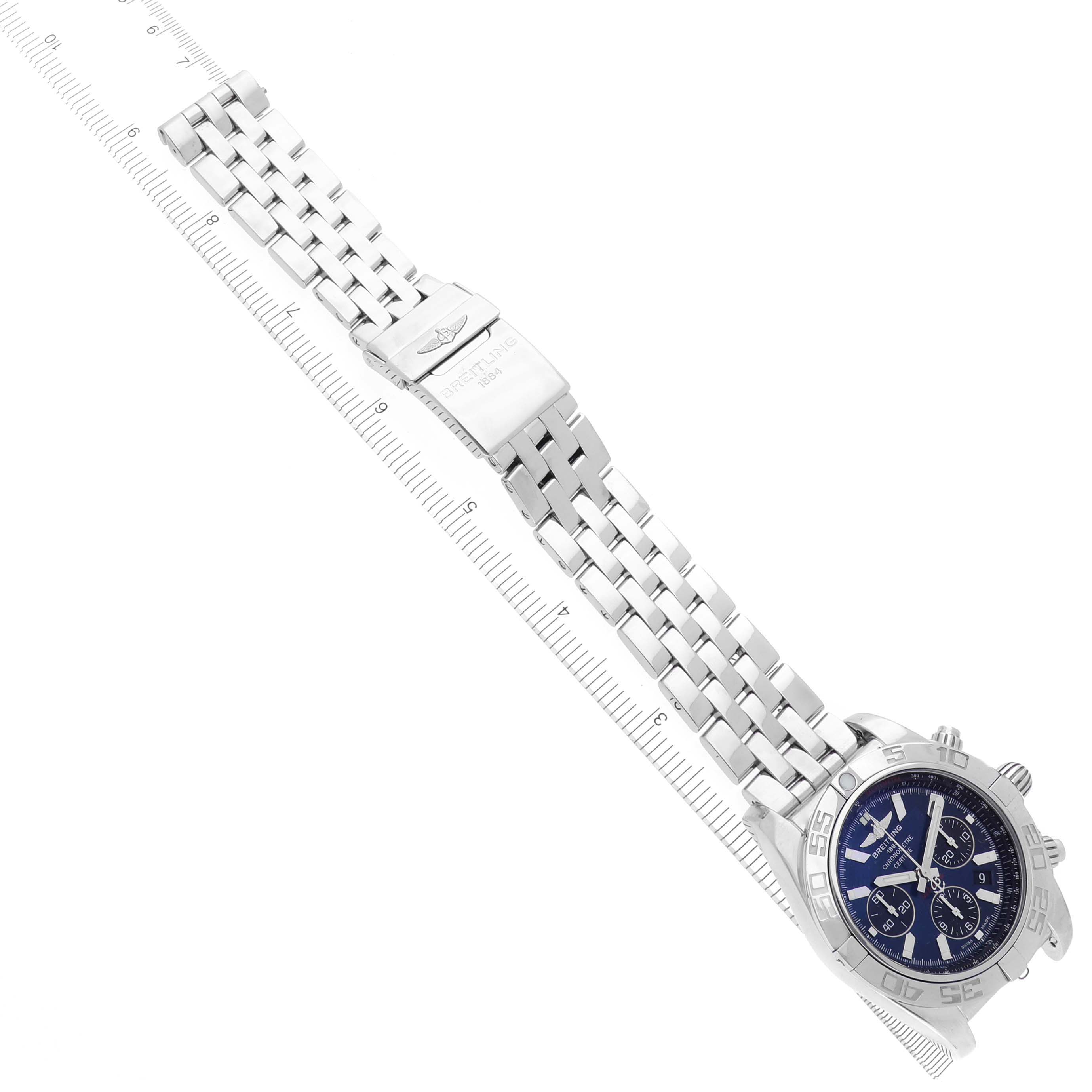 The Breitling Chronomat AB0110/A011C89PA Men's Stainless Steel Blue Dial AB0110/A011C89PA Men's Stainless Steel Blue Dial watch is shown at a side angle, featuring its metal bracelet and clasp, along with the watch face.