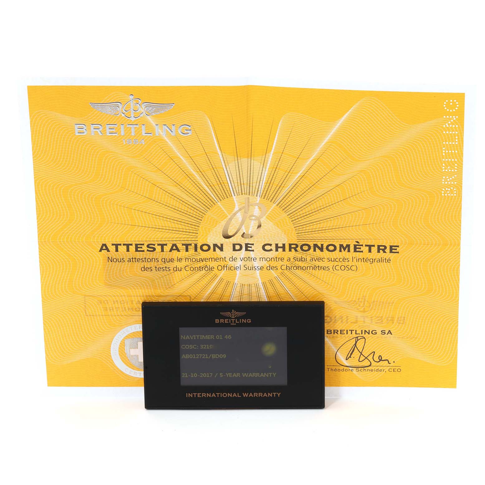 The image shows a Breitling Navitimer AB012721/BD09 Men
s Stainless Steel Black Dial AB012721/BD09 Men
s Stainless Steel Black Dial model
s certificate and international warranty card placed in front of it.