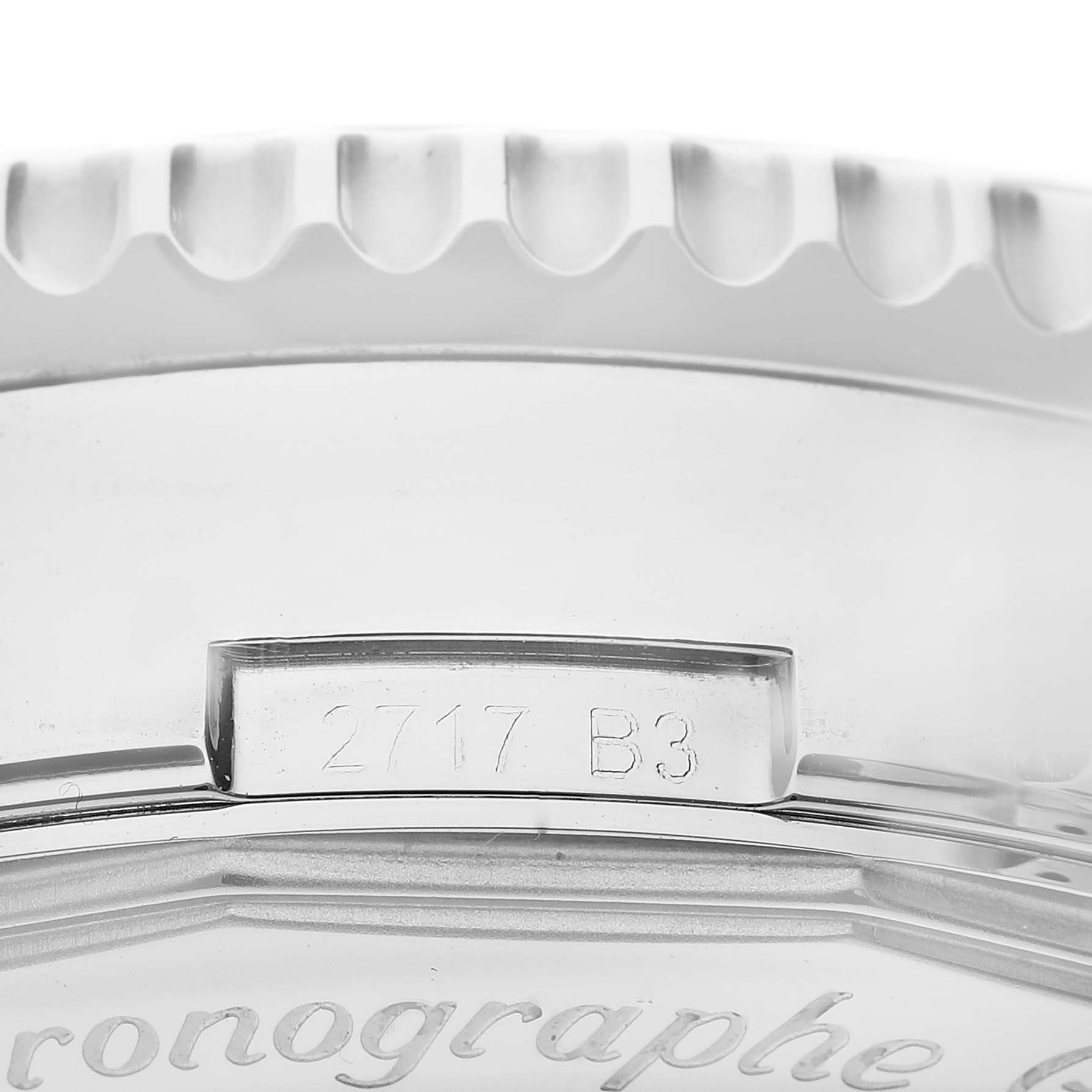 The image shows a close-up of the edge of a Breitling Navitimer AB012721/BD09 Men
s Stainless Steel Black Dial AB012721/BD09 Men
s Stainless Steel Black Dial watch, featuring the serial number and part of the bezel.