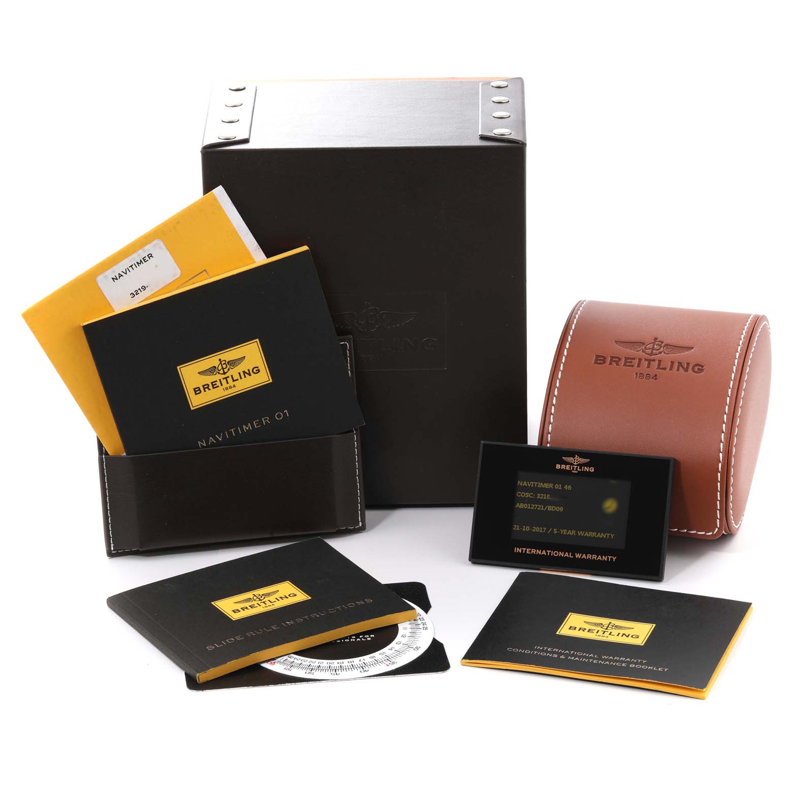 The image shows the Breitling Navitimer AB012721/BD09 Men
s Stainless Steel Black Dial AB012721/BD09 Men
s Stainless Steel Black Dial watch accessories, including manuals, a warranty card, a leather case, and a presentation box.