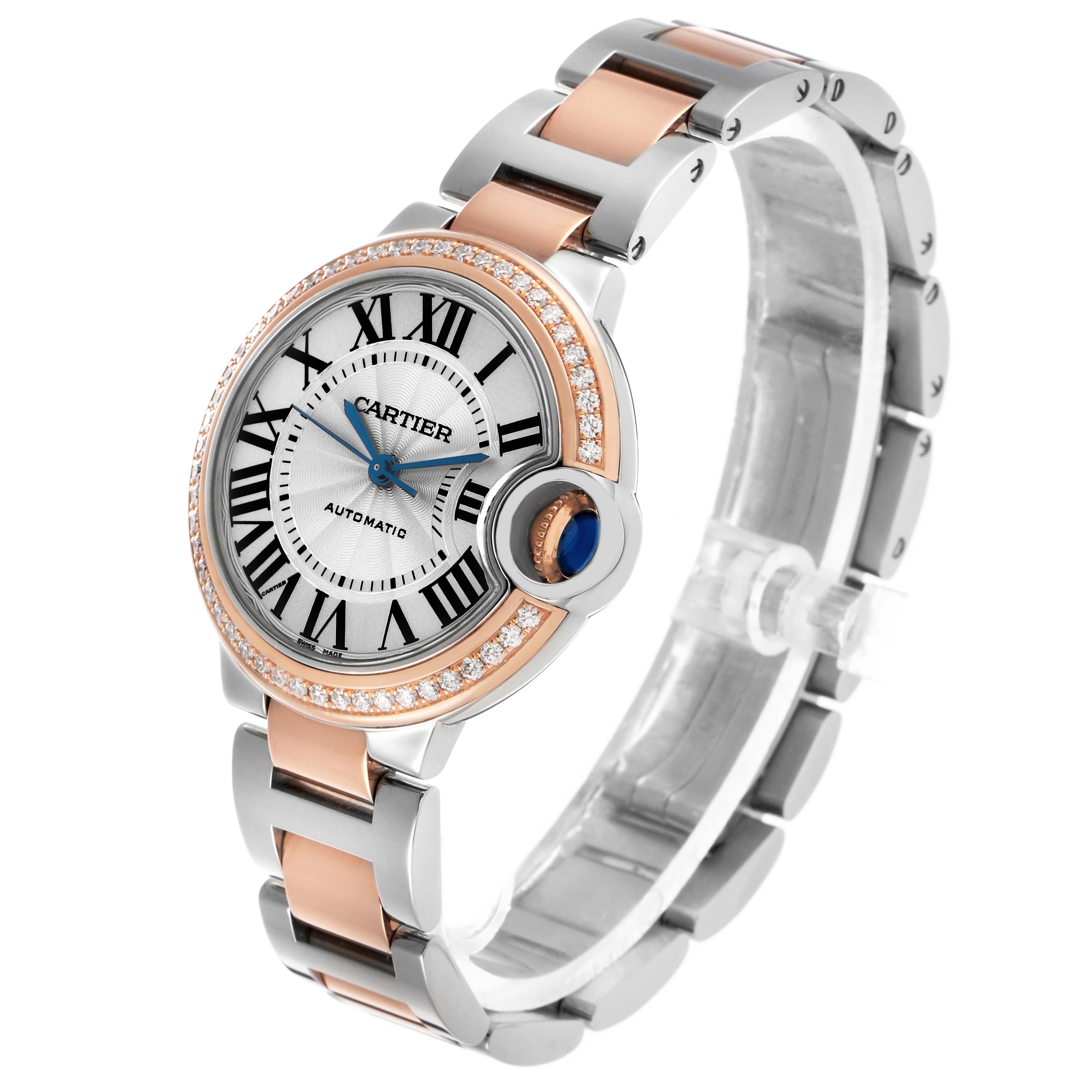 The Cartier Ballon Bleu WE902080 Women's Steel and Gold (two tone) Silver Dial watch is shown at an angle highlighting the face, Roman numerals, bezel with diamonds, and bracelet.