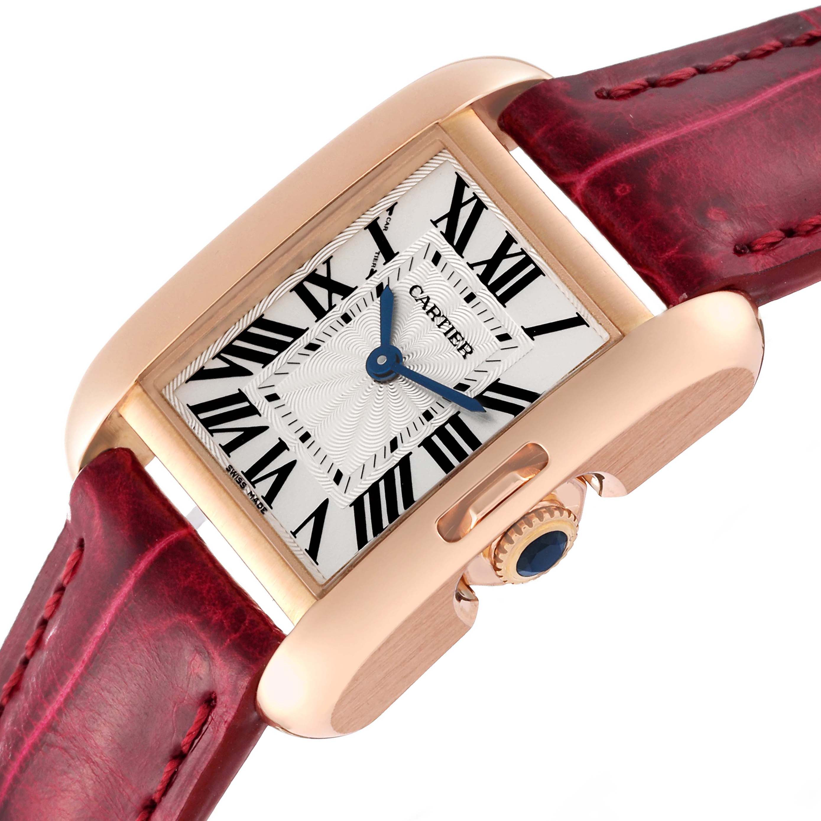 This image shows a close-up, angled view of a Cartier Tank Anglaise W5310027 Women
s Rose Gold Silver Dial W5310027 Women
s Rose Gold Silver Dial watch, displaying its face, crown, and leather strap.