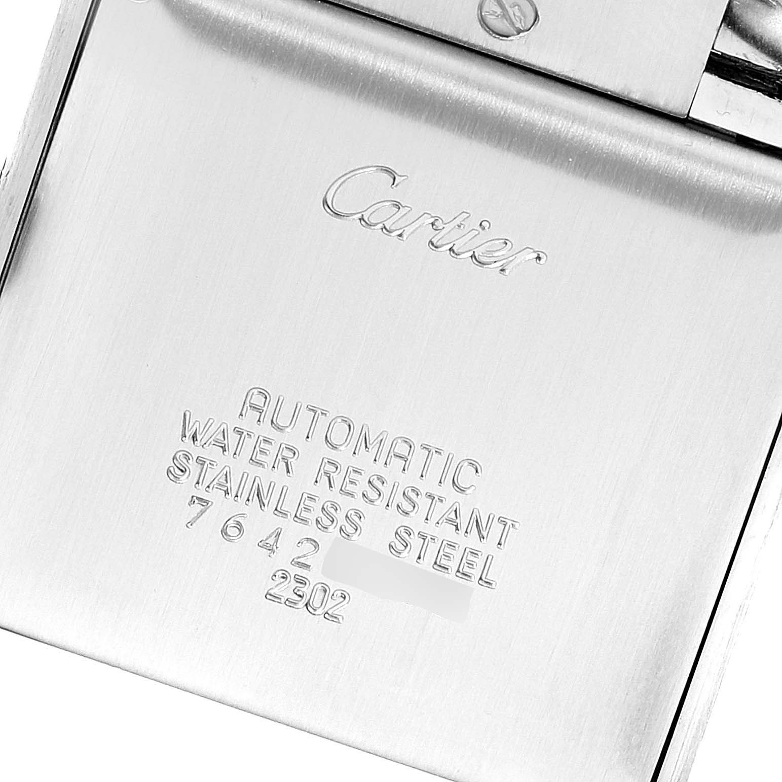 The image shows the back of a Tank Francaise Cartier watch, highlighting its engravings and markings.