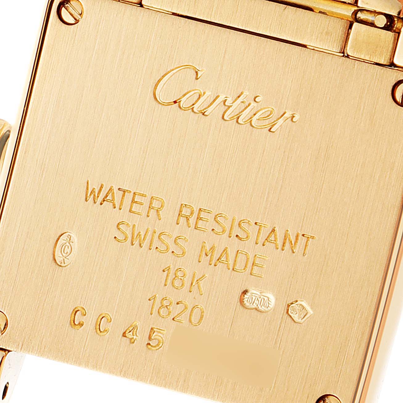 This is a close-up view of the case back of a Cartier Tank Française watch, showing engravings and markings.