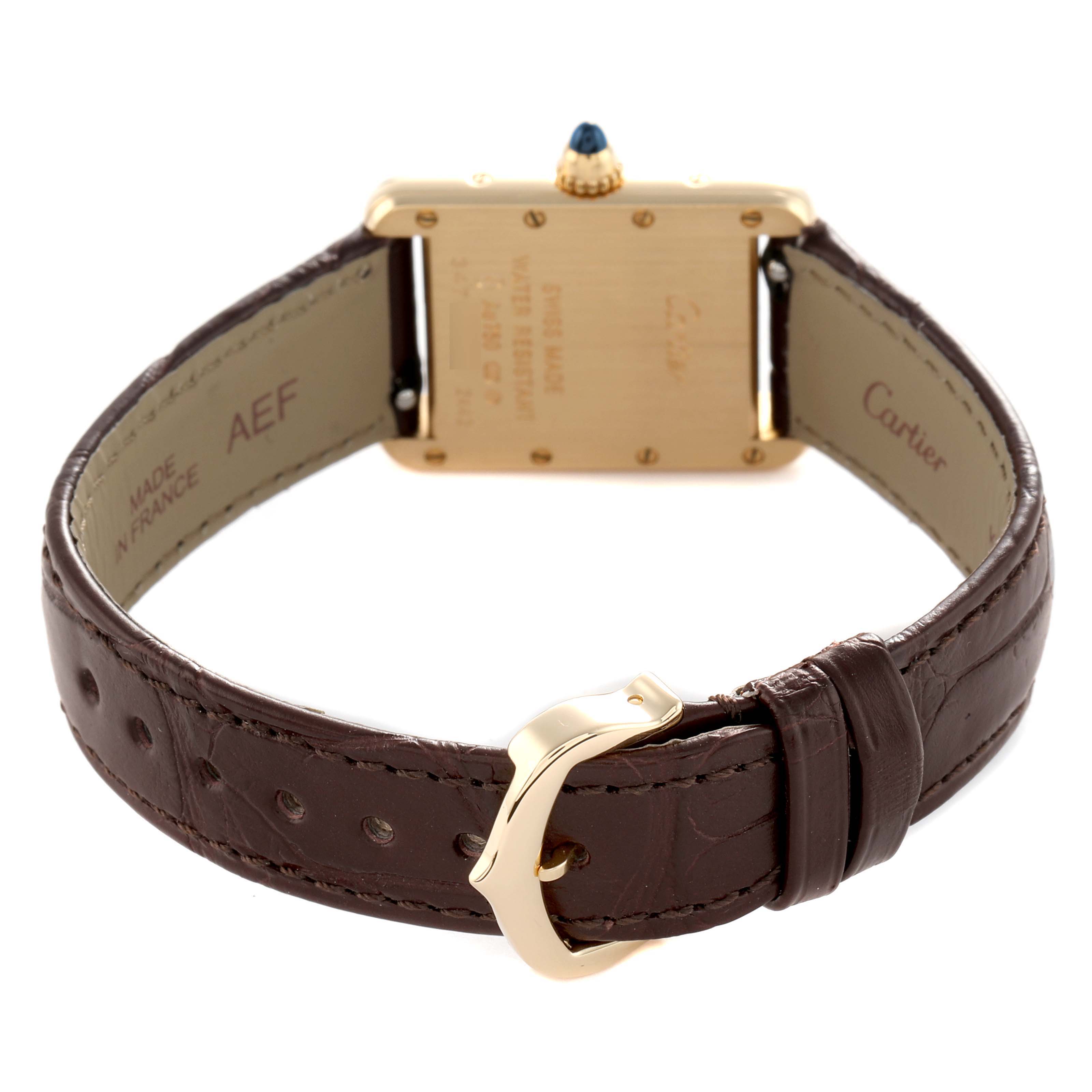 The Cartier Tank Louis W1529856 Women's Yellow Gold Silver Dial watch is shown from the back, highlighting the gold case, sapphire crown, and brown leather strap with buckle.