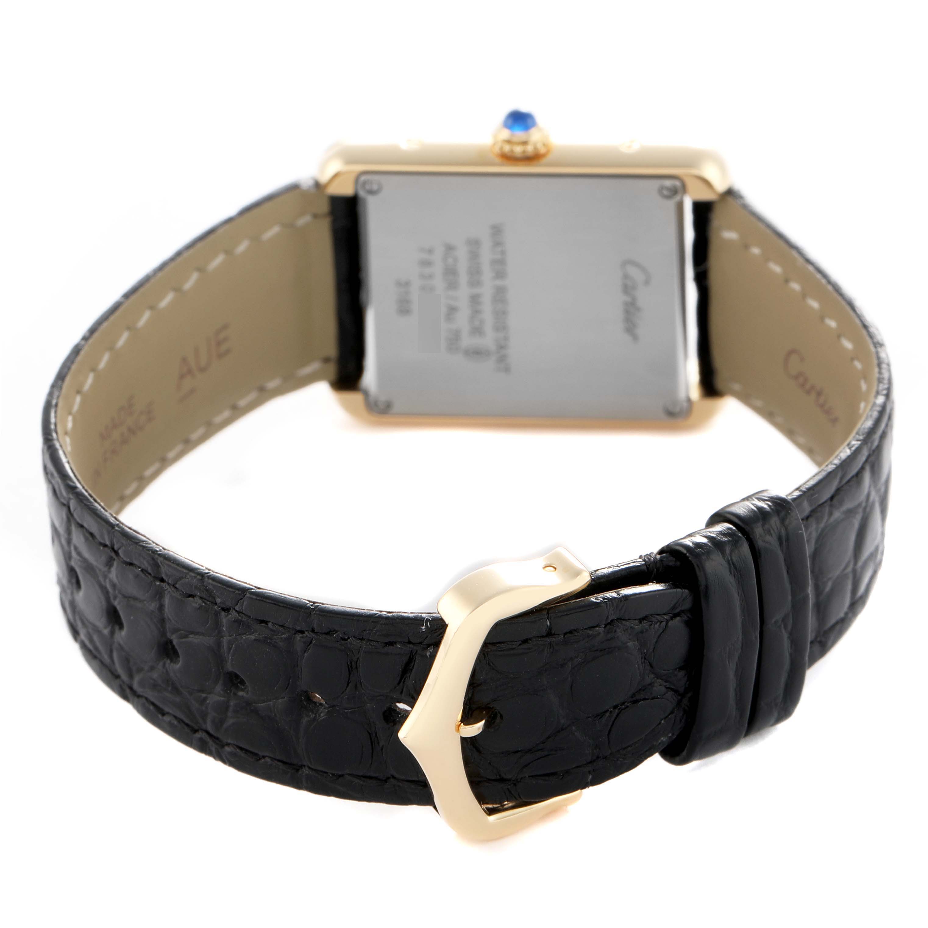 The image shows the back of a Cartier Tank Solo W5200002 Women's Yellow Gold Silver Dial watch with emphasis on the case back, crown, and leather strap with buckle.