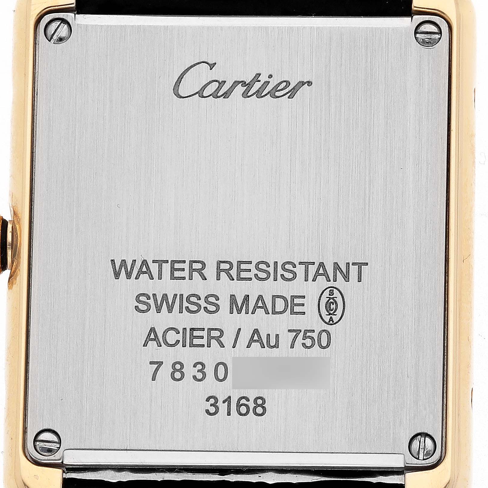 The image shows the back case of a Cartier Tank Solo W5200002 Women's Yellow Gold Silver Dial watch, featuring brand markings and material details.