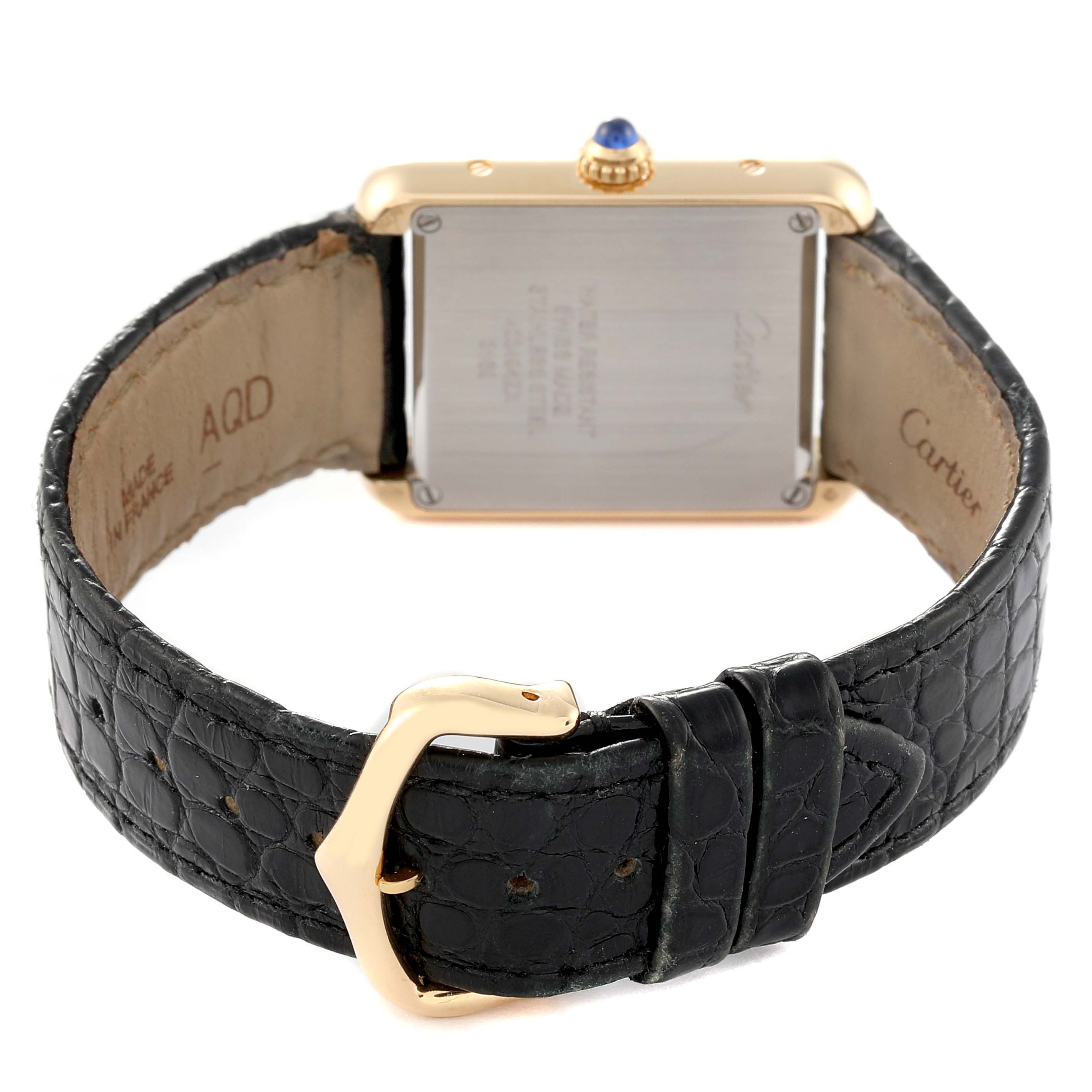 The Cartier Tank Solo W5200002 Women
s Stainless Steel Silver Dial W5200002 Women
s Stainless Steel Silver Dial watch is viewed from the back, showcasing the case back, crown, and black leather strap with a buckle.