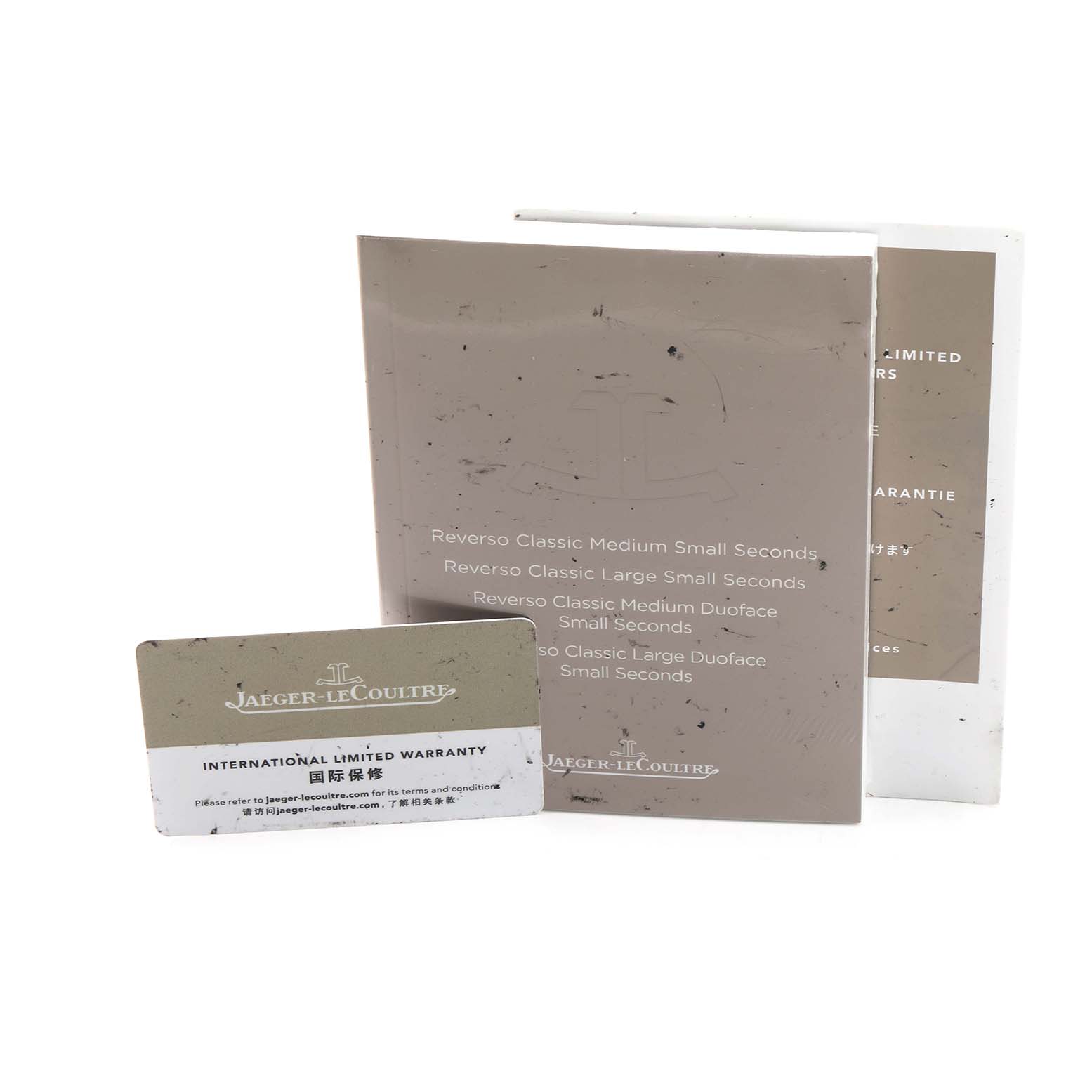 The image shows the instruction manual and warranty card for a Jaeger-LeCoultre Reverso watch.