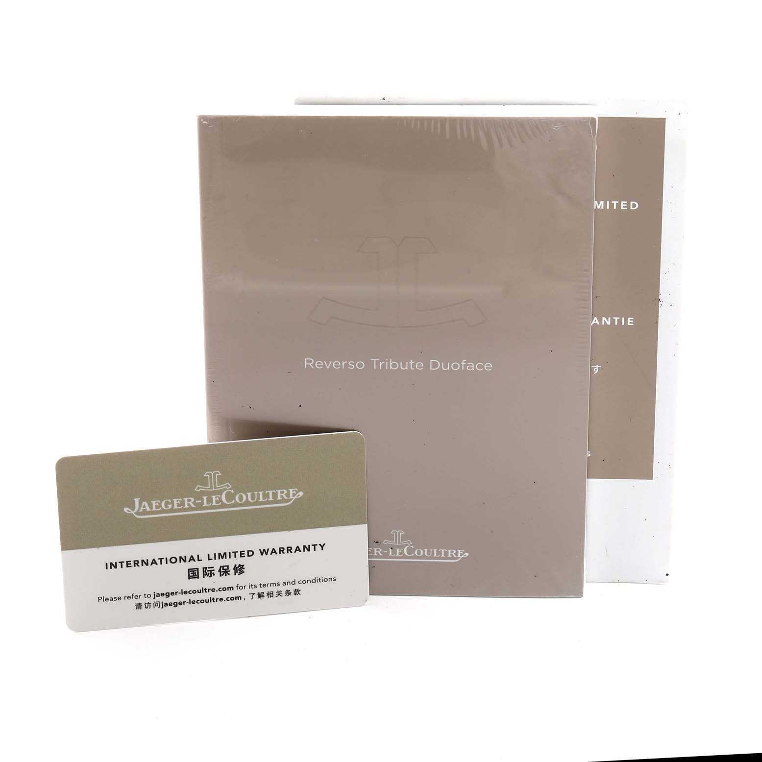 The image shows a Jaeger-LeCoultre Reverso watch's warranty card and manuals, arranged face-up.