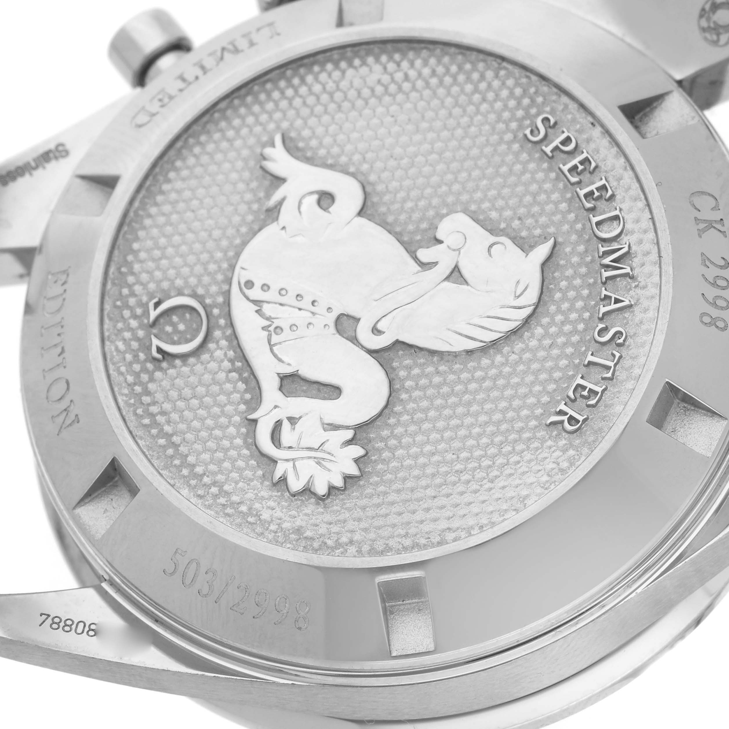 The image shows the case back of an Omega Speedmaster 311.32.40.30.02.001 Men's Stainless Steel Silver Dial 311.32.40.30.02.001 Men's Stainless Steel Silver Dial with engravings and a raised emblem.