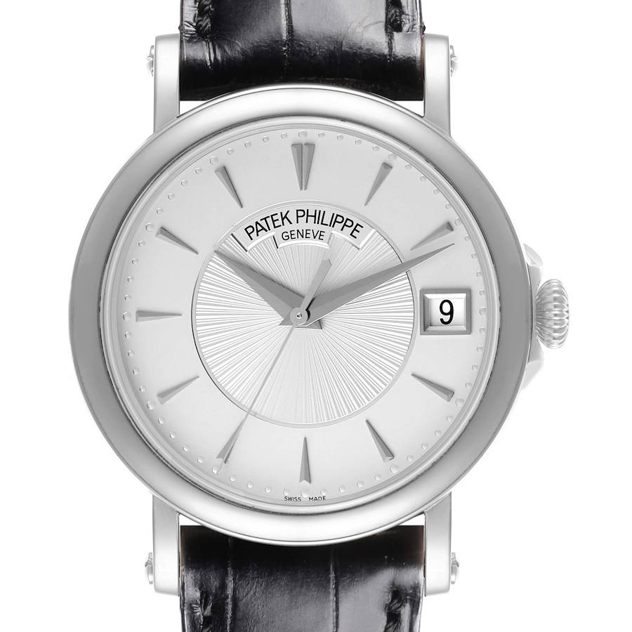 The Patek Philippe Calatrava watch is shown from a front angle, highlighting the dial, hands, and date window.