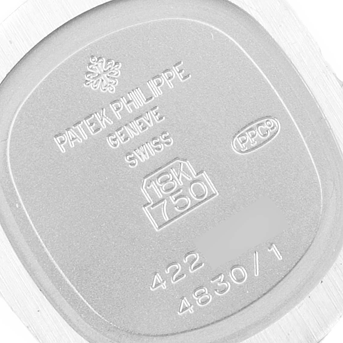 This image shows the engraved back of a Patek Philippe Golden Ellipse 4830 Women's White Gold Mother of Pearl Dial 4830 Women's White Gold Mother of Pearl Dial watch at a close-up angle.