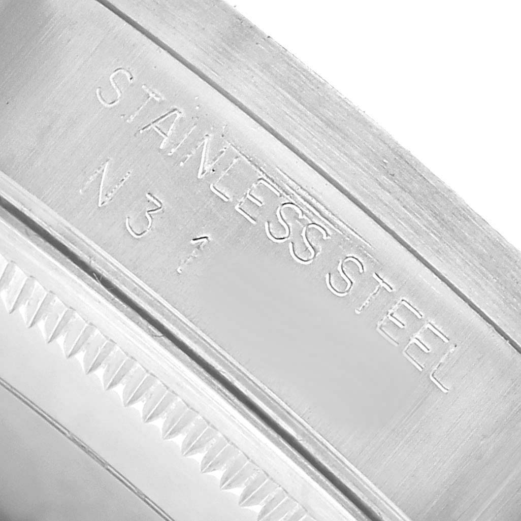 The image shows a close-up of an engraving on the inner bezel of the Rolex Air-King 14010 Men's Stainless Steel White Dial, highlighting the "STAINLESS STEEL" text.