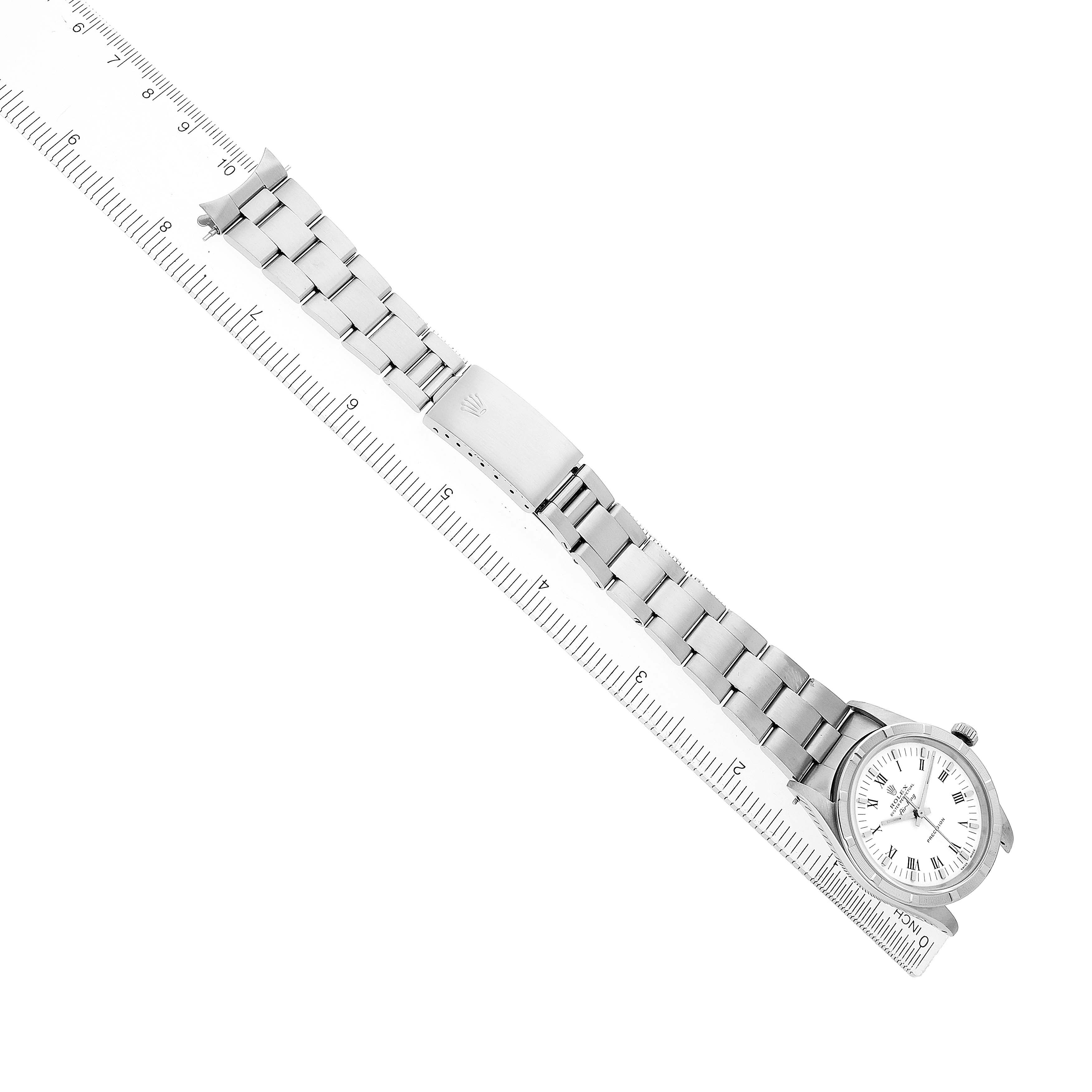 The Rolex Air-King 14010 Men's Stainless Steel White Dial watch is shown from an overhead angle, highlighting the bracelet and clasp on a ruler for scale.