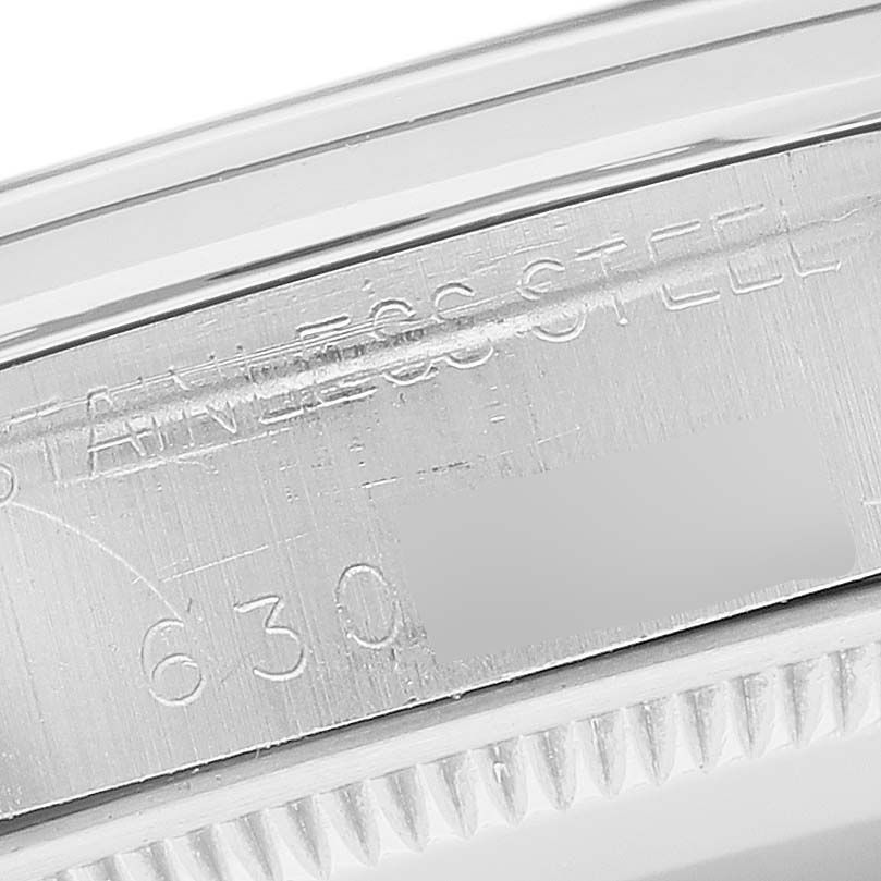 This image shows a close-up of the engraved serial number and "STAINLESS STEEL" text on the side of the case of a Rolex Vintage Collection 5500 Men's Stainless Steel Silver Dial 5500 Men's Stainless Steel Silver Dial watch.