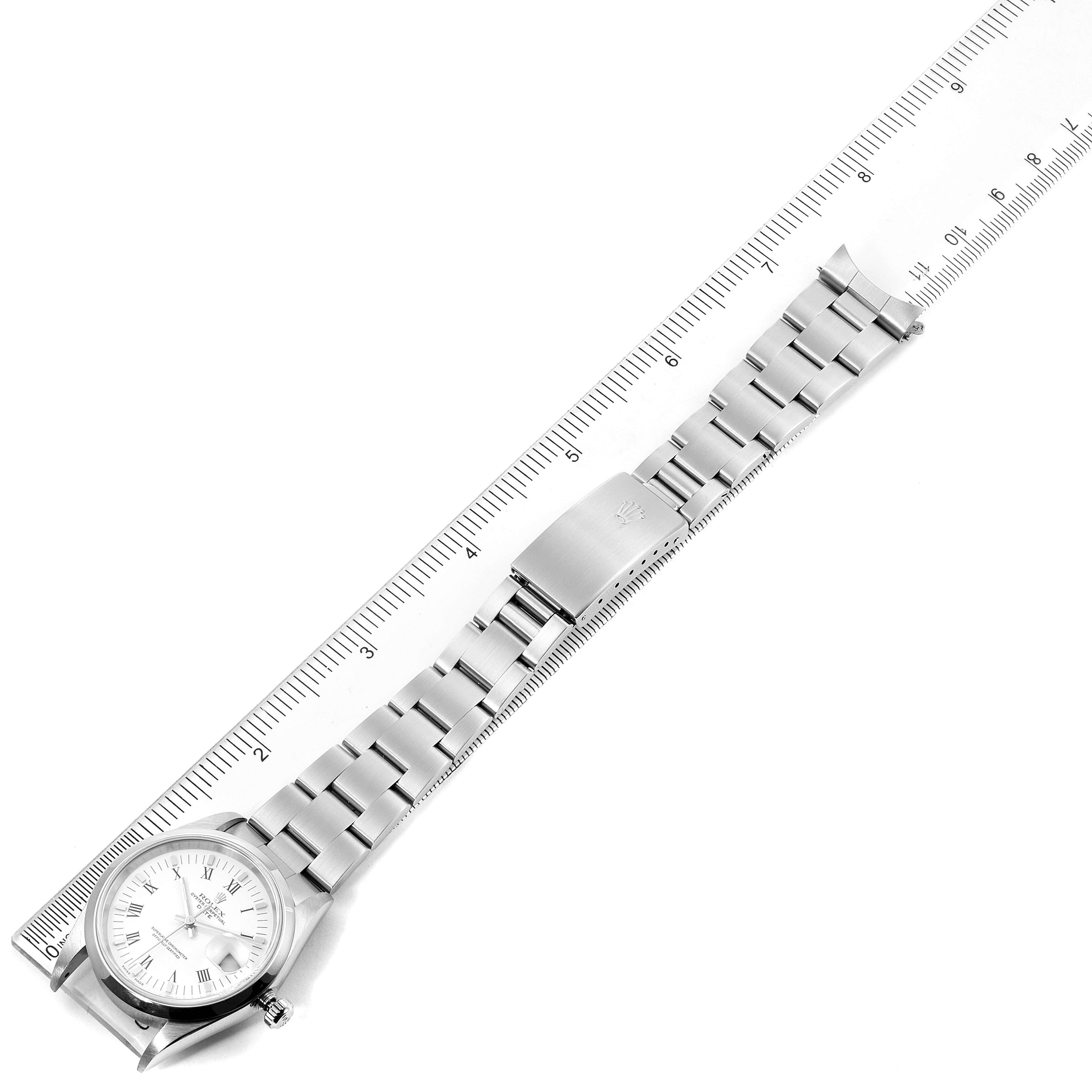 The image shows a Rolex Date 15200 Men's Stainless Steel White Dial 15200 Men's Stainless Steel White Dial model watch with its stainless steel bracelet laid flat alongside a ruler for measurement.