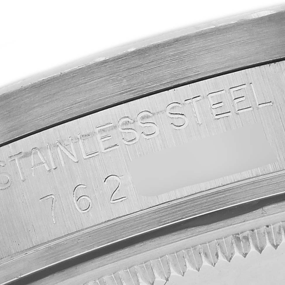 The image shows a close-up of the Rolex Date 15010 Men's Stainless Steel Silver Dial 15010 Men's Stainless Steel Silver Dial model, focusing on the stainless steel case back with engraved text.