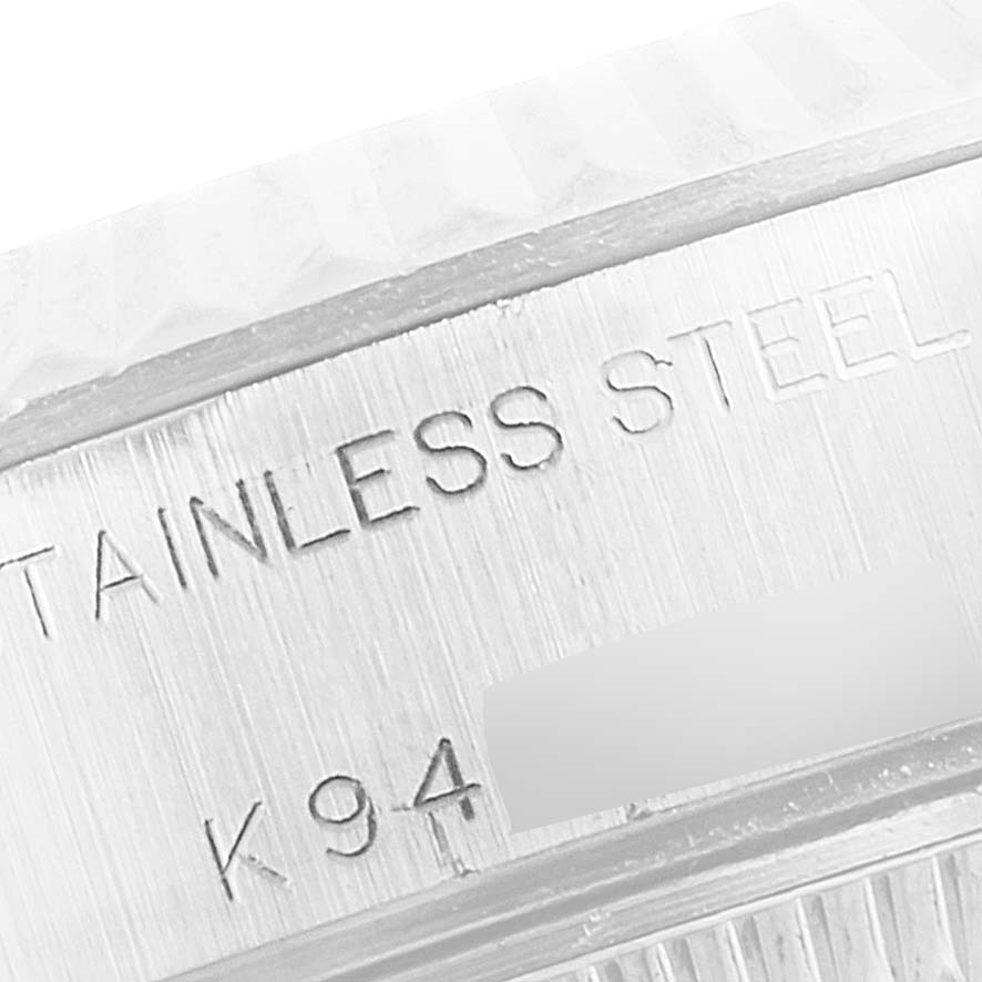 The close-up image shows the side engraving of a Rolex Datejust 79174 Women's Stainless Steel Blue Dial 79174 Women's Stainless Steel Blue Dial watch, indicating its stainless steel material.