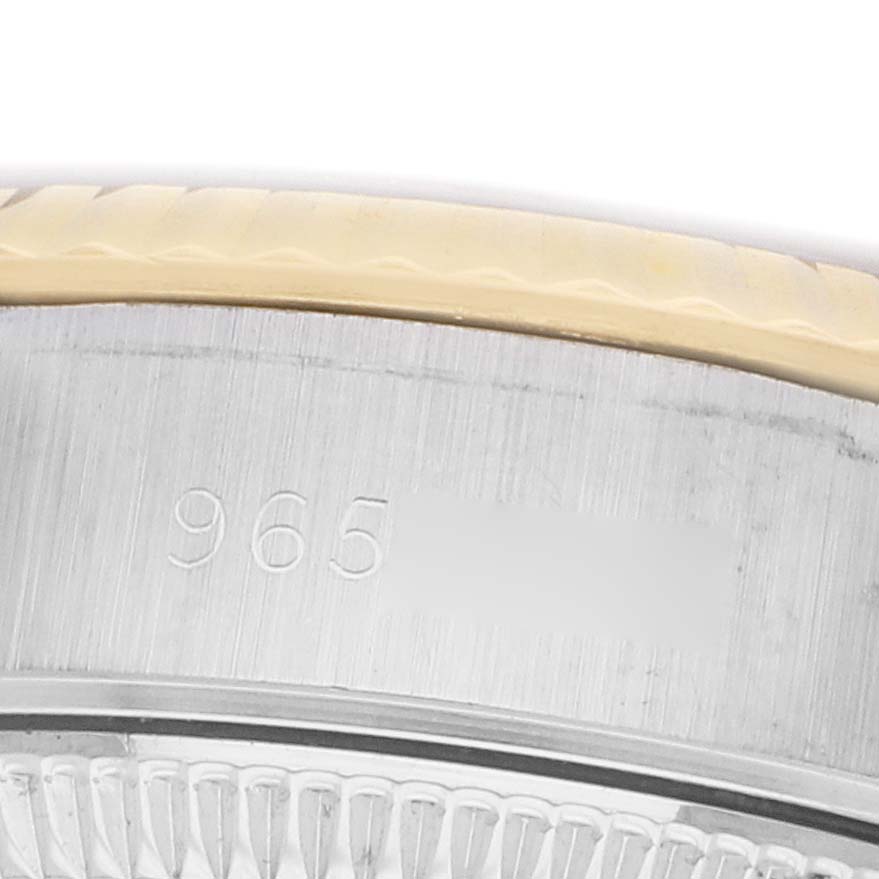 The image shows a close-up of the bezel and case edge with engravings on the Rolex Datejust 69173 Women's Steel and Gold (two tone) Champagne Dial.