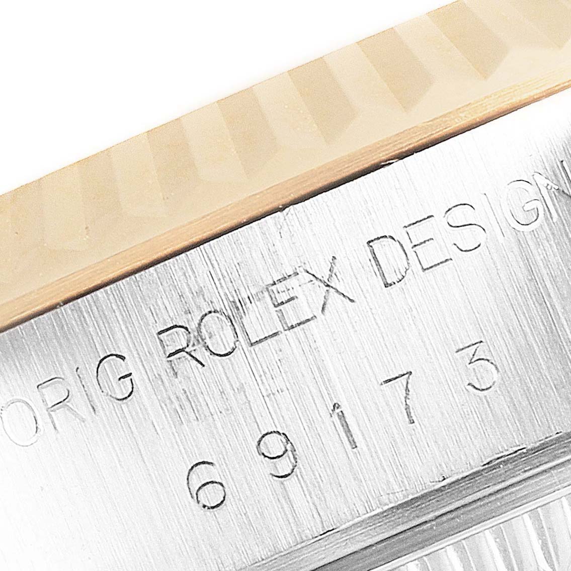 This image shows a close-up view of the engraved bezel and serial number on a Rolex Datejust 69173 Women
s Steel and Gold (two tone) Champagne Dial 69173 Women
s Steel and Gold (two tone) Champagne Dial watch.