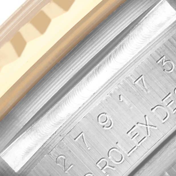 The image shows a close-up of the Rolex Datejust 279173 Women's Steel and Gold (two tone) Champagne Dial 279173 Women's Steel and Gold (two tone) Champagne Dial's bezel and engraved inner ring.