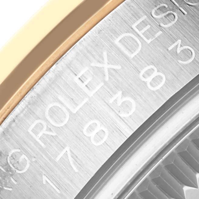 The image shows a close-up of the edge and side engraving on a Rolex Mid-Size 178383 Women's Steel and Gold (two tone) Green Dial 178383 Women's Steel and Gold (two tone) Green Dial model watch case.