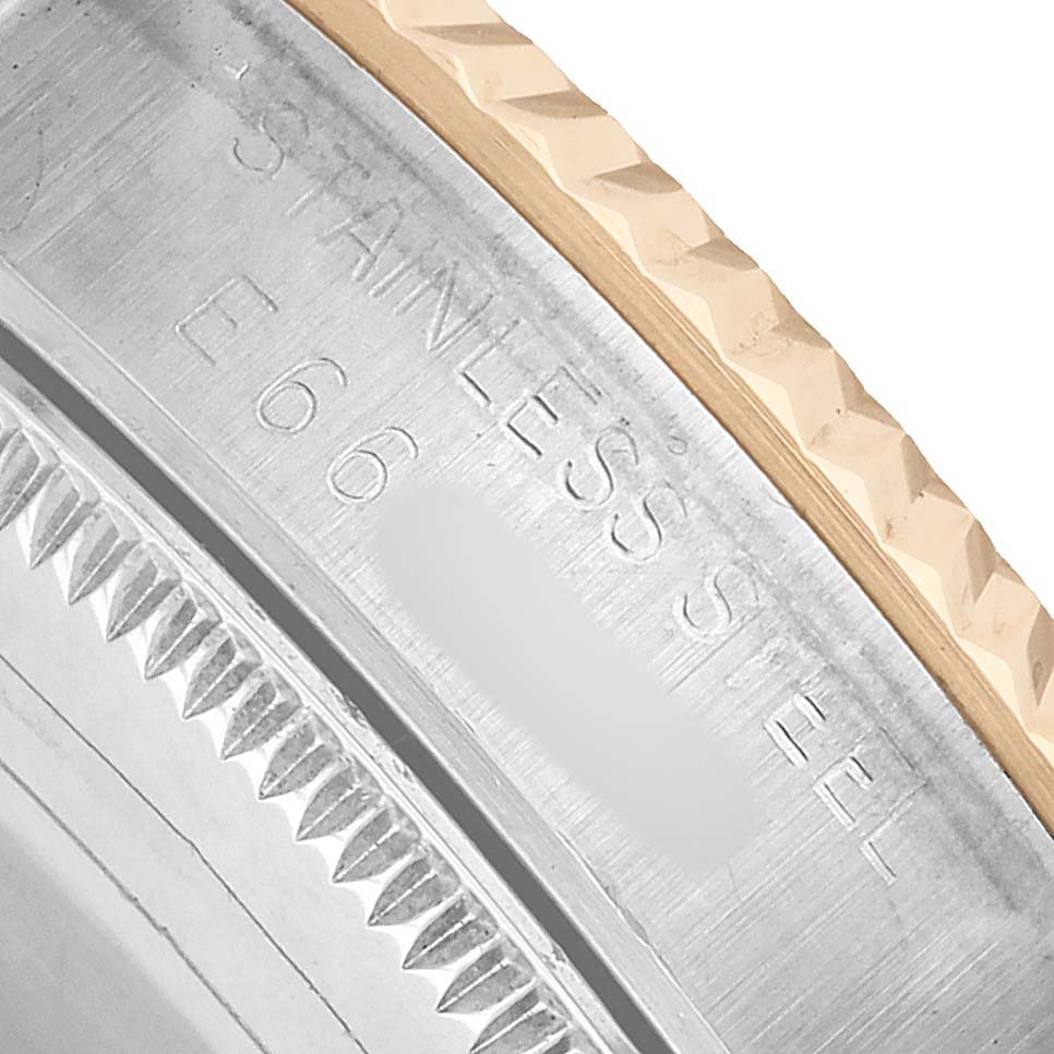 The image shows a close-up of the Rolex Datejust 68273 Women's Steel and Gold (two tone) Grey Dial bezel and the engraved "STAINLESS STEEL" marking on its side.
