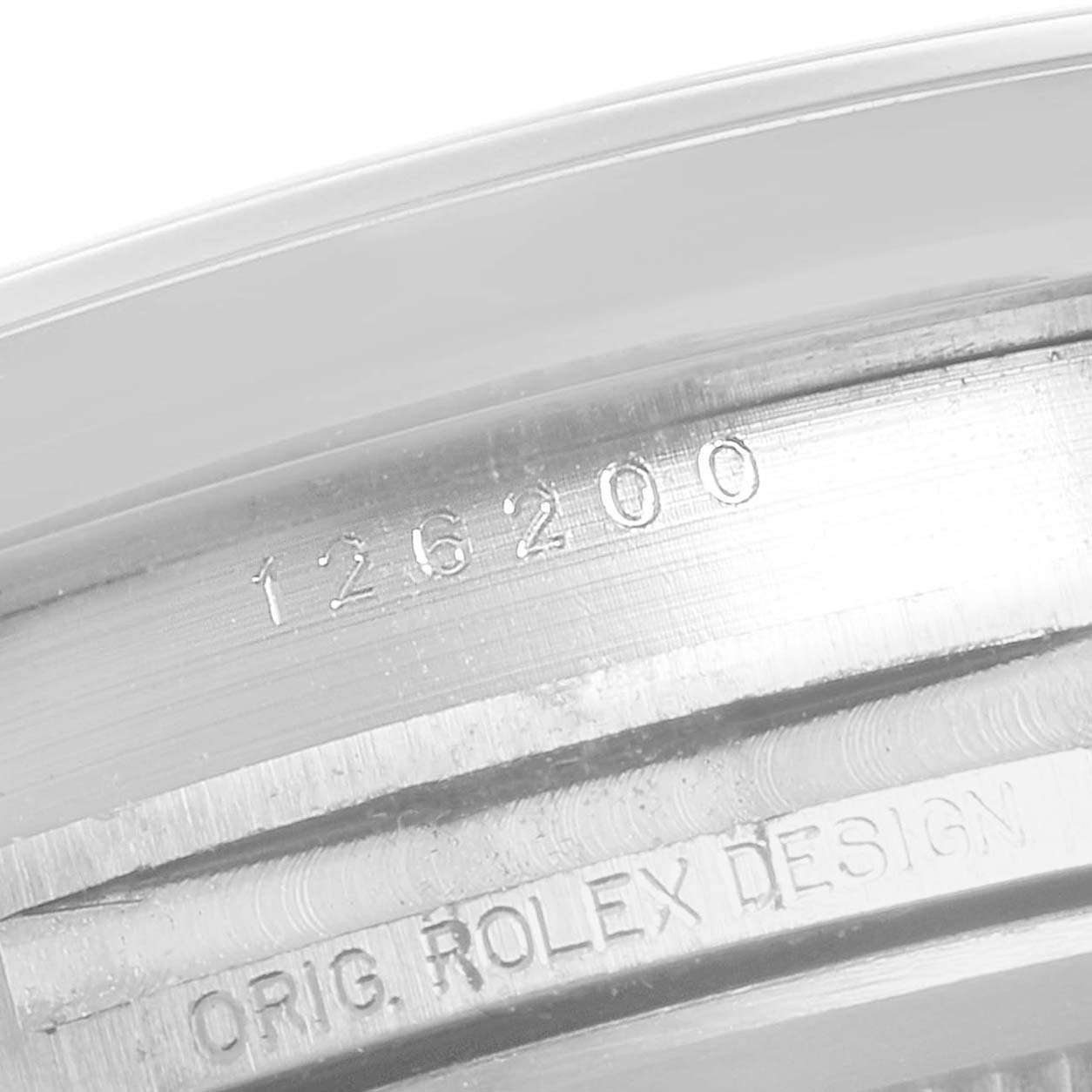 This close-up image shows the engraved model number and "Orig. Rolex Design" text on the case of a Rolex Datejust 126200 Men's Stainless Steel Silver Dial 126200 Men's Stainless Steel Silver Dial watch.