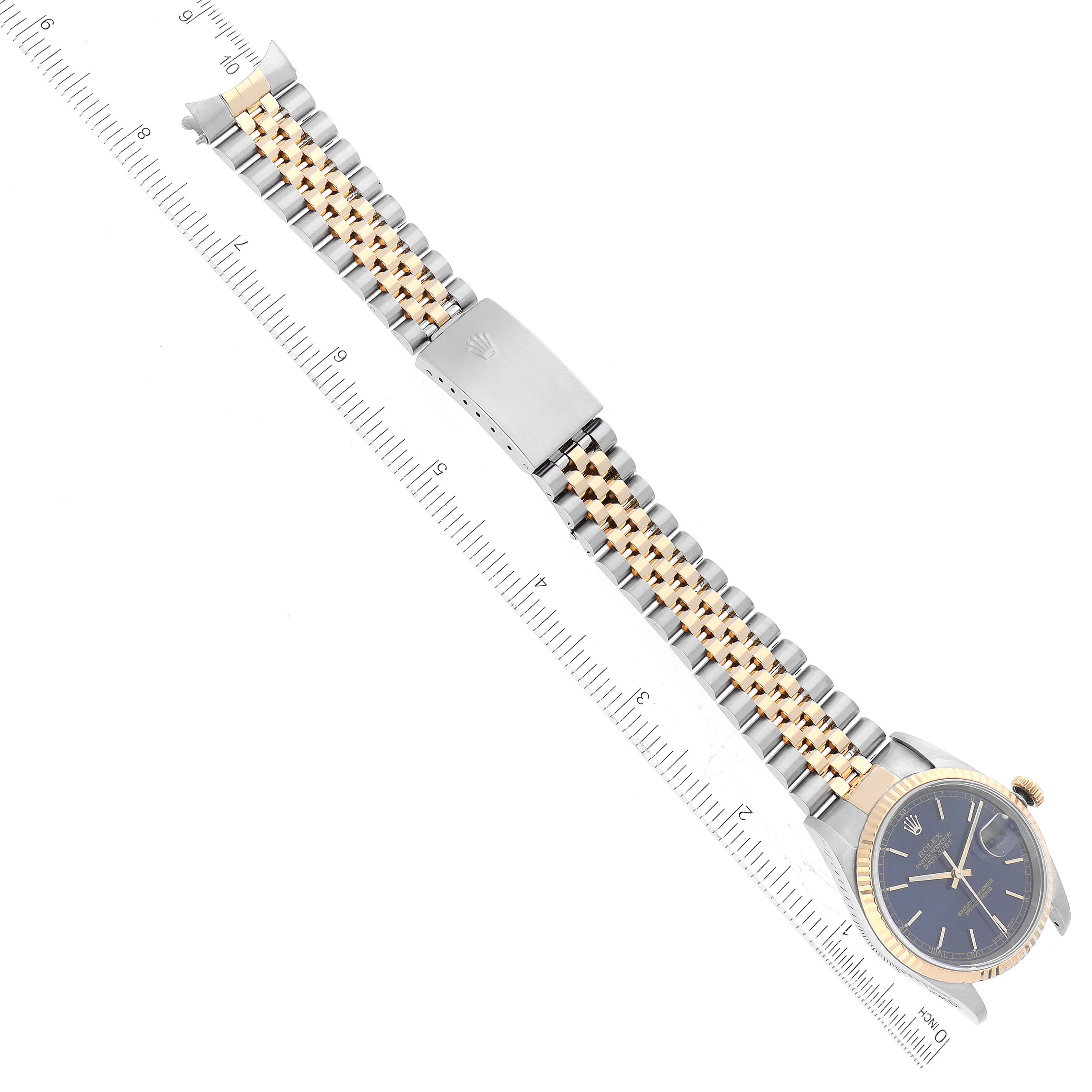 The image shows a Rolex Datejust 16233 Men's Steel and Gold (two tone) Blue Dial 16233 Men's Steel and Gold (two tone) Blue Dial watch at an overhead angle, highlighting its bracelet, clasp, and face.