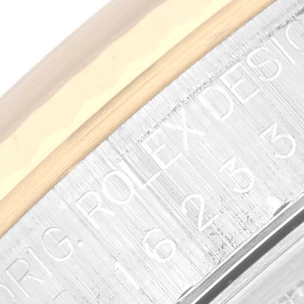 The image shows a close-up of the side engraving on the case of a Rolex Datejust 16233 Men's Steel and Gold (two tone) Blue Dial 16233 Men's Steel and Gold (two tone) Blue Dial watch.