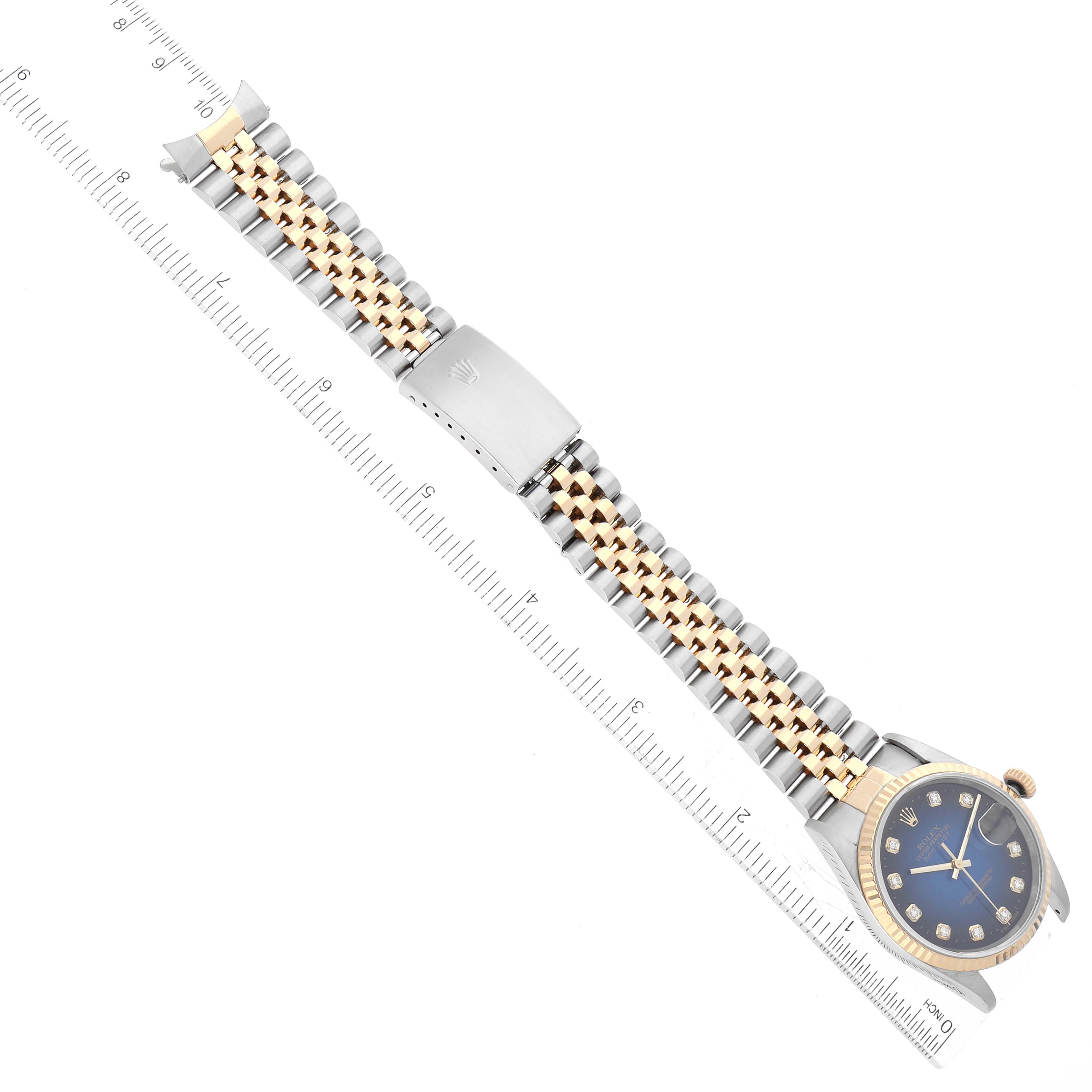 This image shows a Rolex Datejust 16233G Men's Steel and Gold (two tone) Blue Dial 16233G Men's Steel and Gold (two tone) Blue Dial watch from a top-down angle, revealing the full bracelet with a clasp and the watch face.