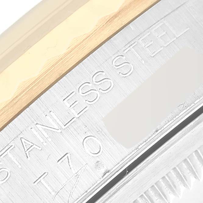 This image shows a close-up of the case edge on a Rolex Datejust 16233G Men's Steel and Gold (two tone) Blue Dial 16233G Men's Steel and Gold (two tone) Blue Dial model, highlighting its "STAINLESS STEEL" engraving.