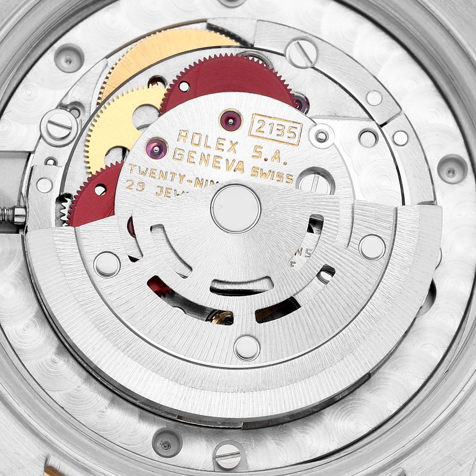 This image shows a close-up of the movement mechanism in a Rolex Mid-Size 68273G Women's Steel and Gold (two tone) Champagne Dial 68273G Women's Steel and Gold (two tone) Champagne Dial watch model, featuring gears and inscriptions.