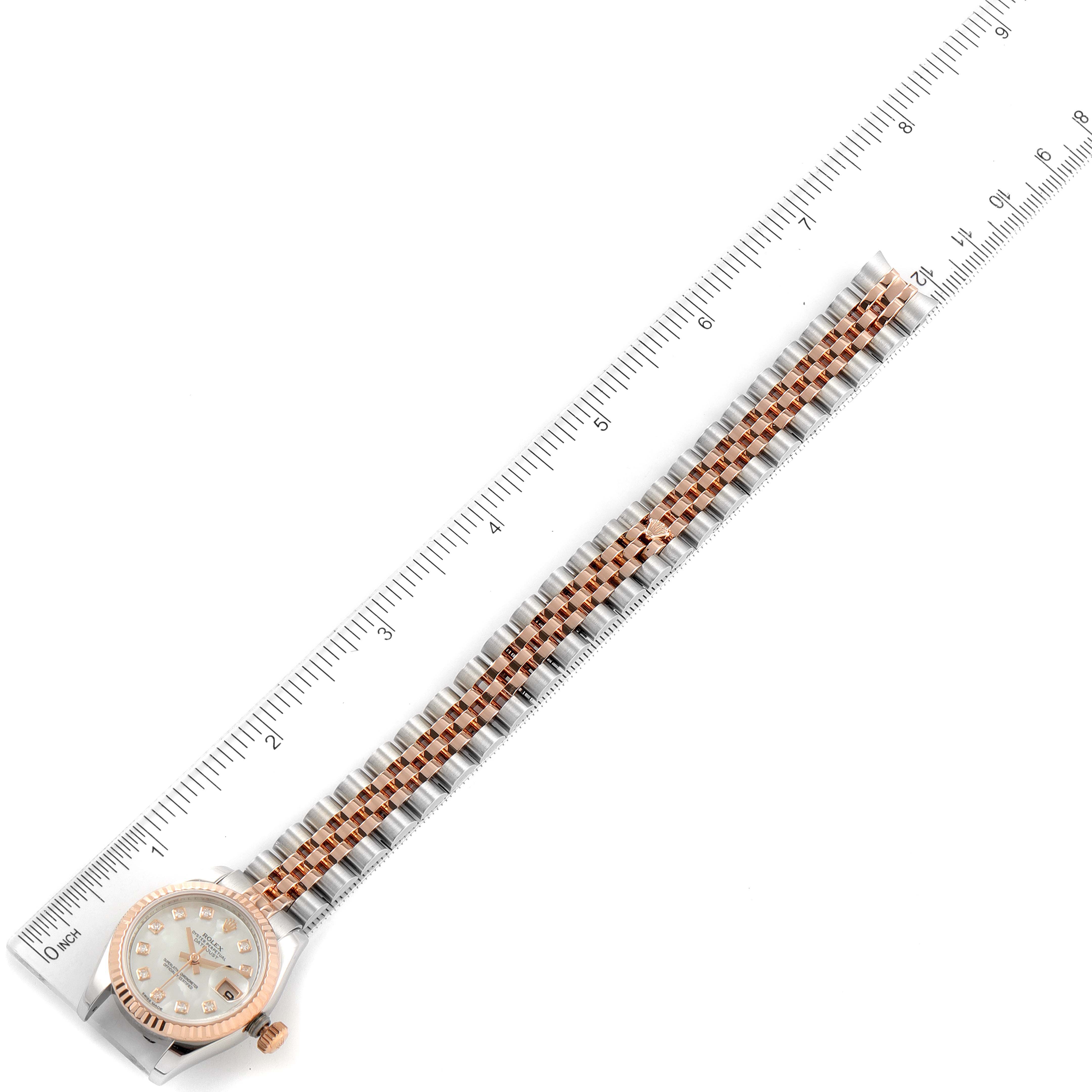 This image shows the full length of a Rolex Datejust 179171 Women
s Steel and Gold (two tone) Mother of Pearl Dial 179171 Women
s Steel and Gold (two tone) Mother of Pearl Dial watch placed alongside a ruler for scale.