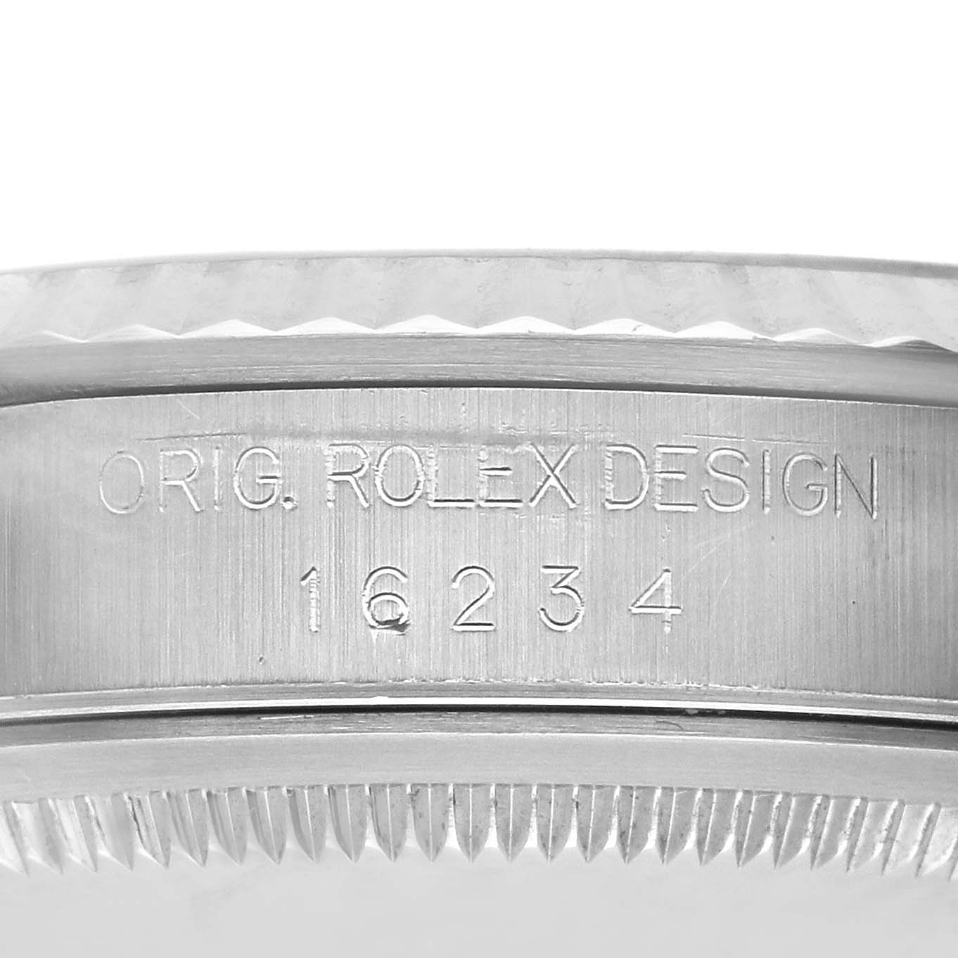 The image shows a close-up of the side of a Rolex Datejust 16234 Men
s Stainless Steel Silver Dial 16234 Men
s Stainless Steel Silver Dial watch, focusing on the engraved serial and model numbers.