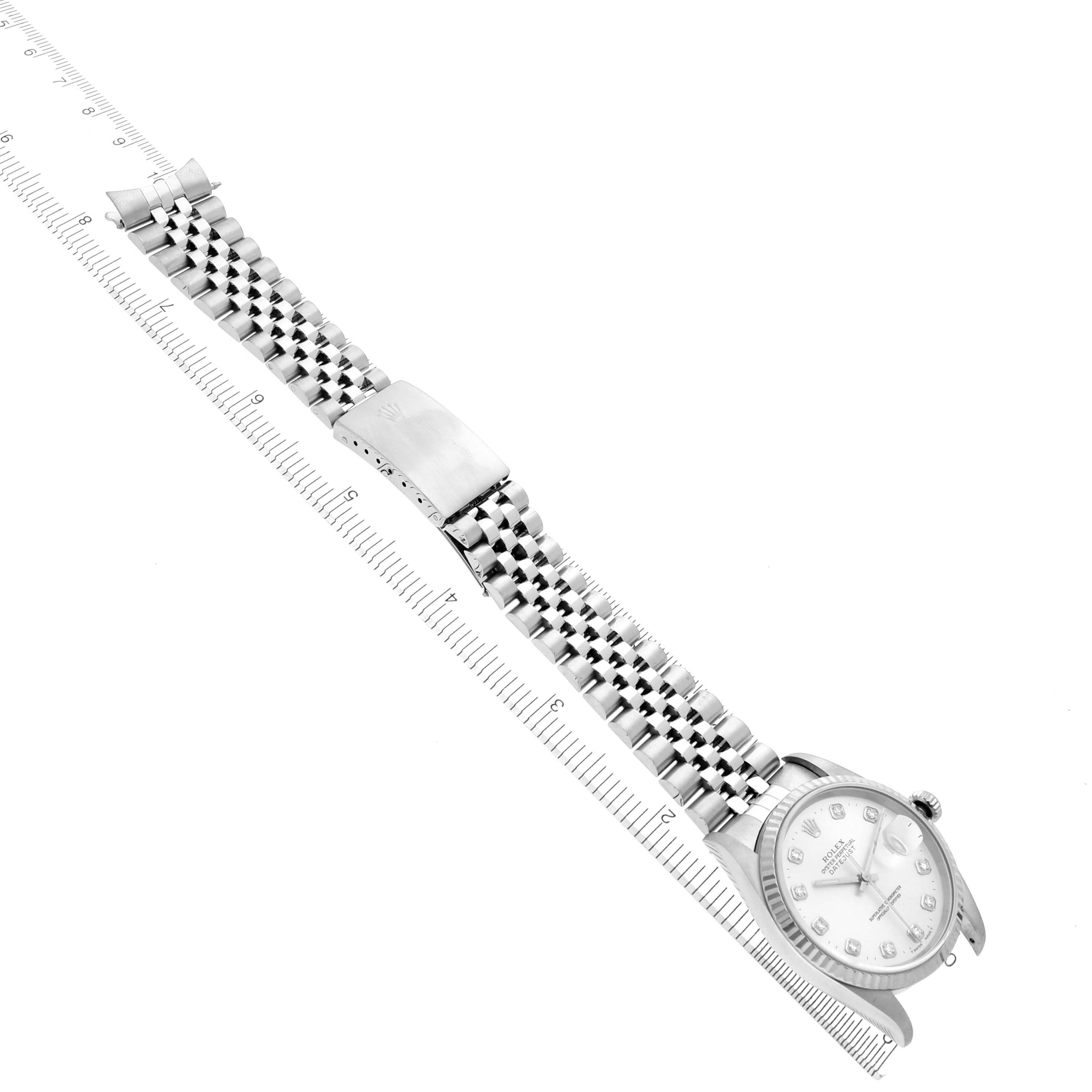 The Rolex Datejust 16234 Men
s Stainless Steel Silver Dial 16234 Men
s Stainless Steel Silver Dial watch is shown at an angle displaying the face, bracelet, and clasp fully extended alongside a measuring ruler.