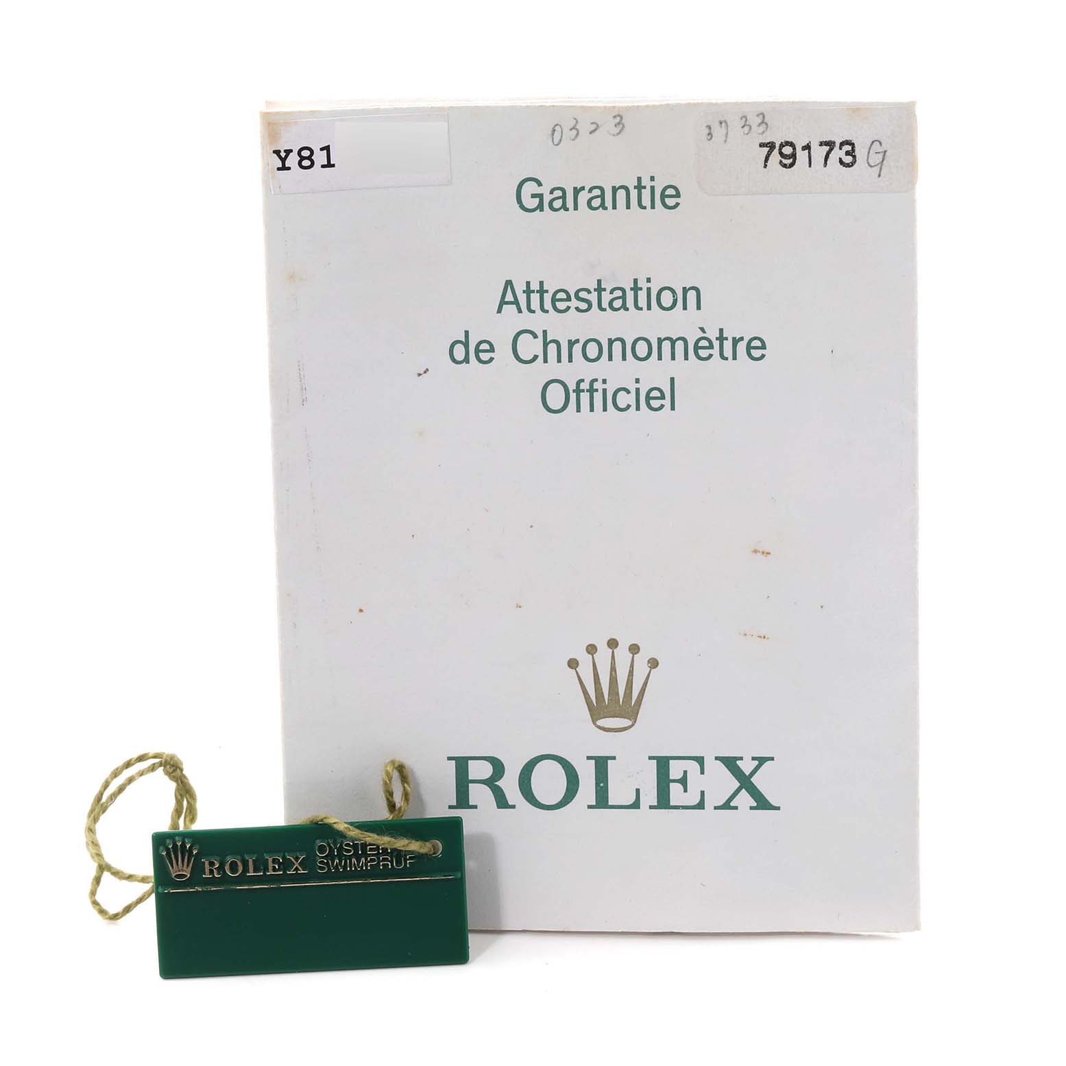 The image shows a Rolex Datejust 79173 Women's Steel and Gold (two tone) Black Dial 79173 Women's Steel and Gold (two tone) Black Dial warranty booklet and a green Rolex tag with the brand's logo.