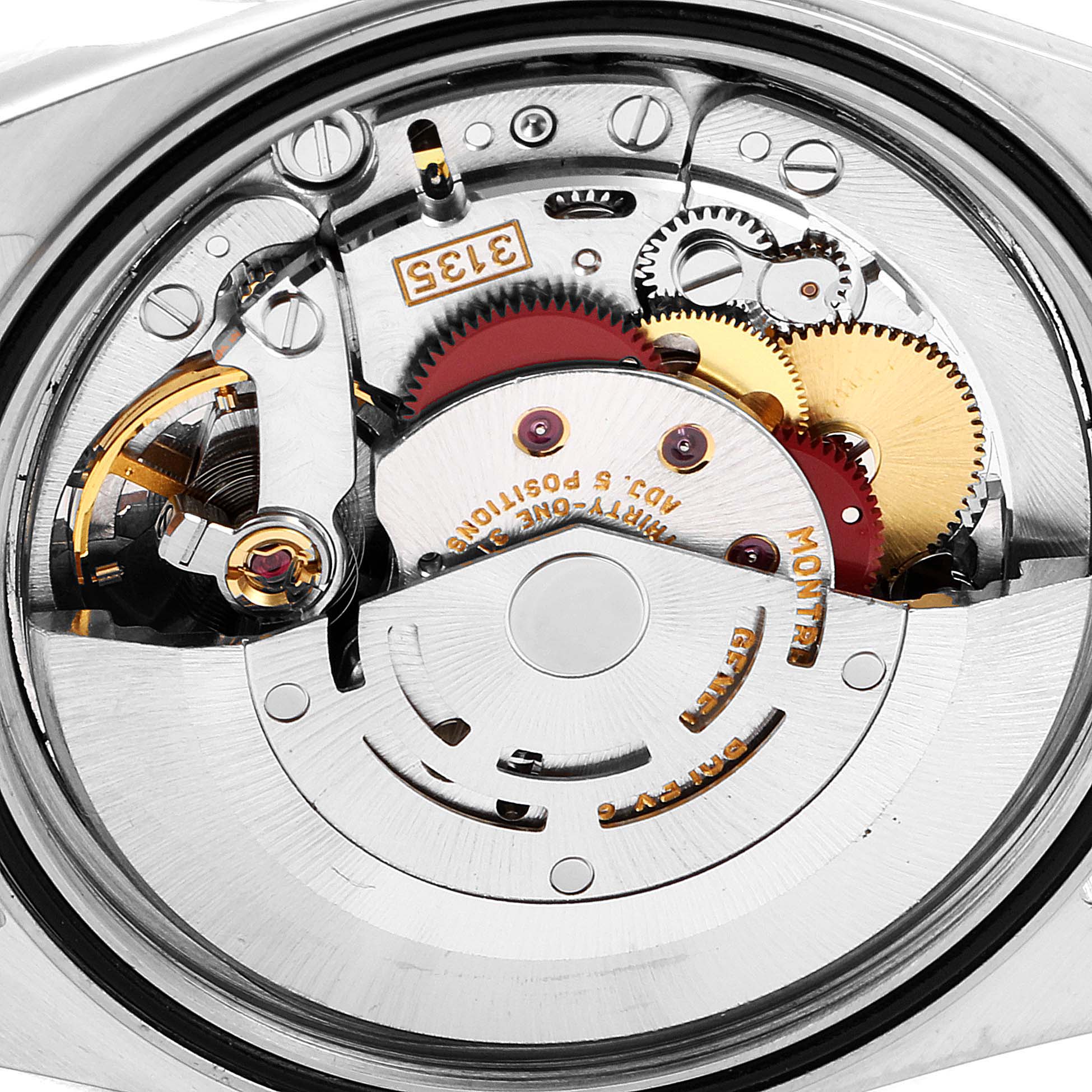 The image shows a close-up of the movement mechanism of a Rolex Datejust 16233 Men's Steel and Gold (two tone) Black Dial 16233 Men's Steel and Gold (two tone) Black Dial watch, highlighting gears and components.
