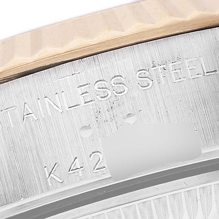 This close-up image shows the side of the case and part of the bezel of a Rolex Datejust 79173 Women's Steel and Gold (two tone) White Dial 79173 Women's Steel and Gold (two tone) White Dial watch, highlighting the "Stainless Steel" inscription and serial number.