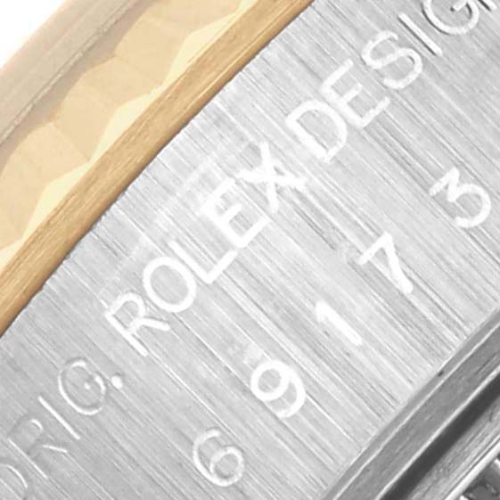 The image shows the side of the Rolex Datejust 69173 Women's Steel and Gold (two tone) Blue Dial 69173 Women's Steel and Gold (two tone) Blue Dial, focusing on the engraved bezel and text.