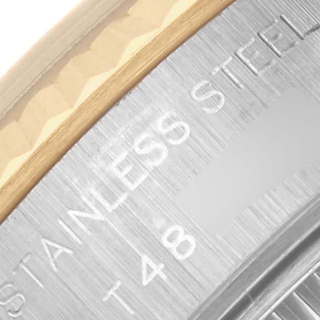 The image shows a close-up of the Rolex Datejust 69173 Women's Steel and Gold (two tone) Blue Dial 69173 Women's Steel and Gold (two tone) Blue Dial's stainless steel and gold bezel with engraved text.