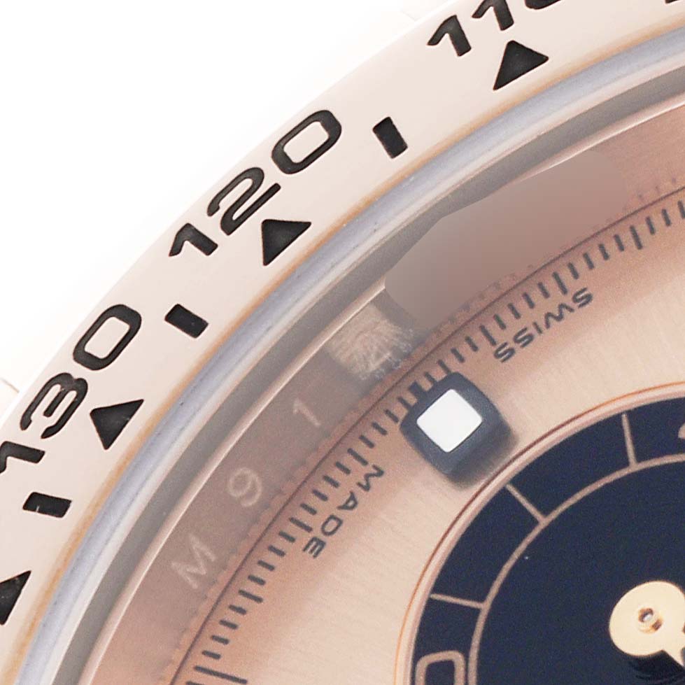 The image shows a close-up of the bezel and dial of a Rolex Daytona 116505 Men's Rose Gold Champagne Dial 116505 Men's Rose Gold Champagne Dial watch, highlighting the tachymetric scale and part of the sub-dial.