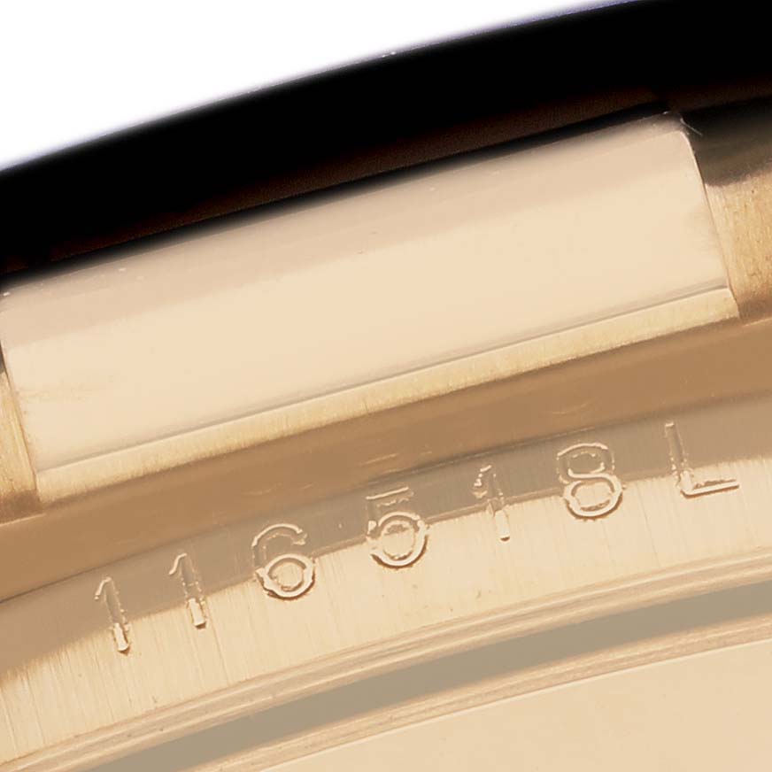 The image shows a close-up of the serial number and part of the bezel on a Rolex Daytona 116518LN Men's Yellow Gold Champagne Dial 116518LN Men's Yellow Gold Champagne Dial watch.