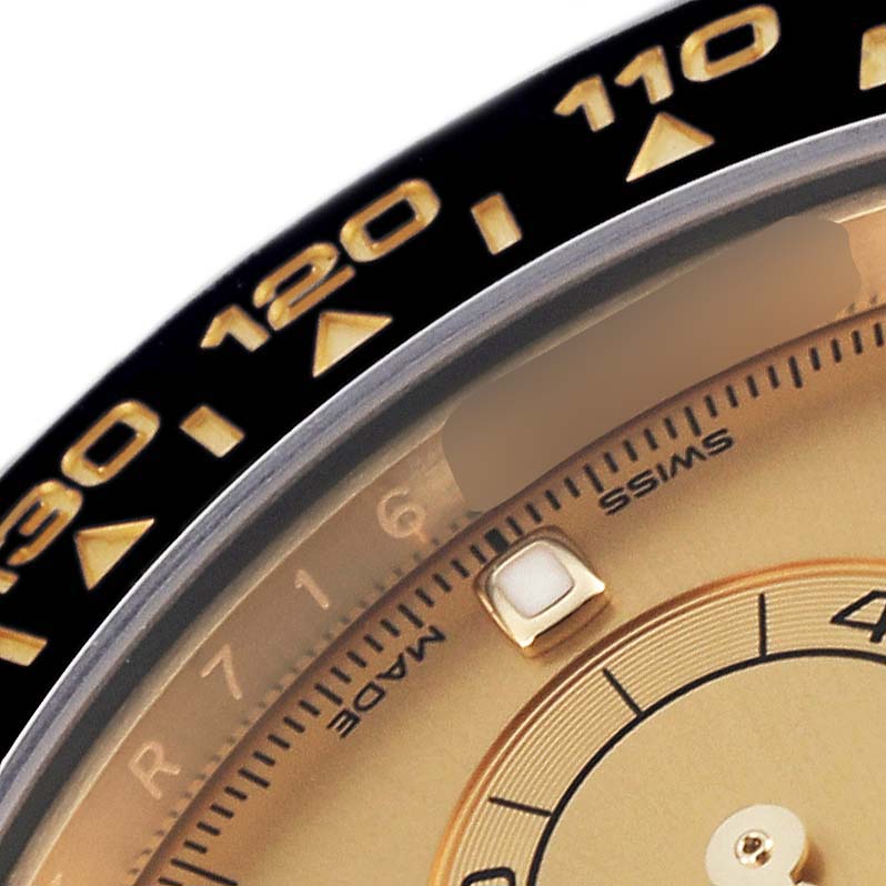 The image shows a close-up of the dial and bezel of a Rolex Daytona 116518LN Men's Yellow Gold Champagne Dial 116518LN Men's Yellow Gold Champagne Dial, highlighting the tachymetric scale and part of the face.