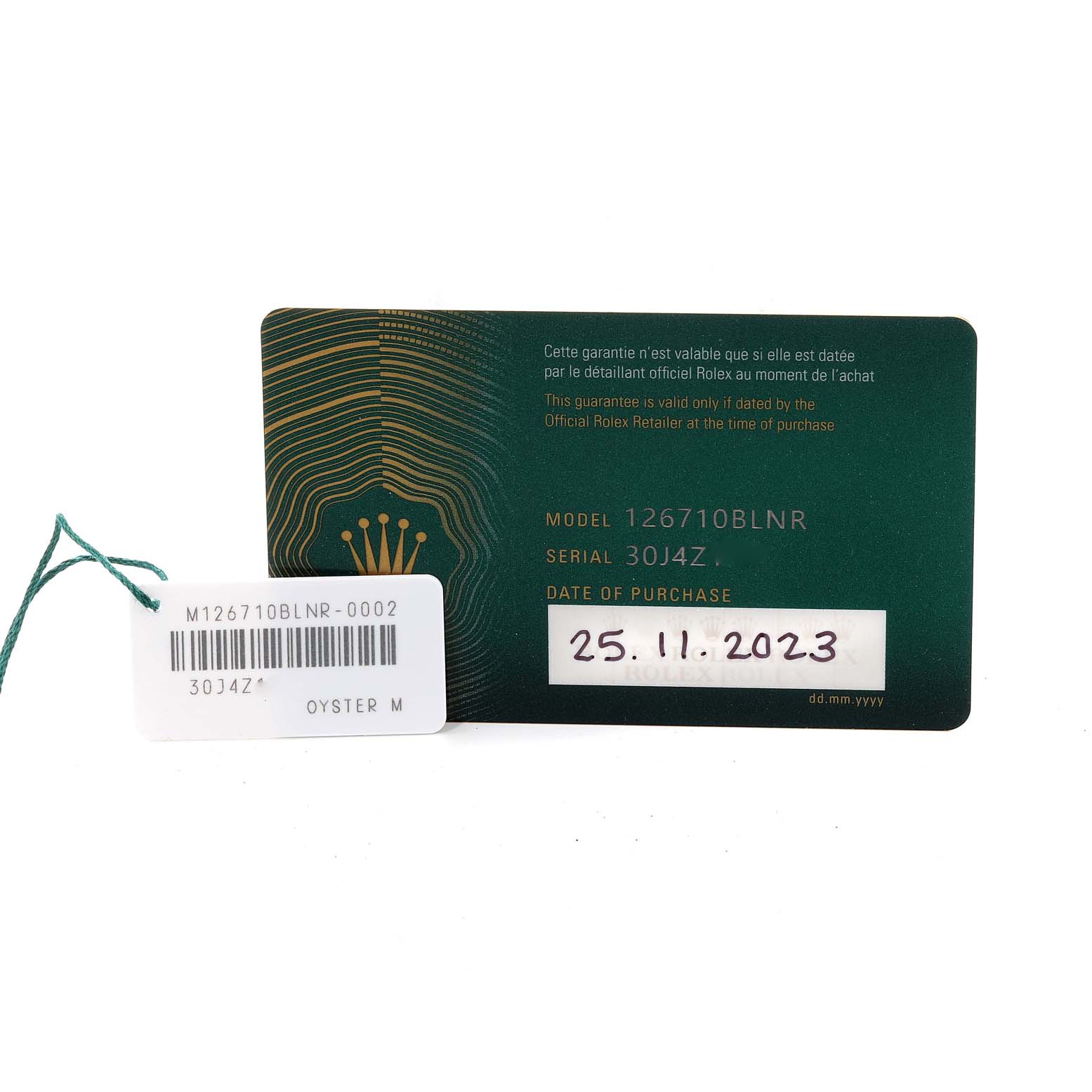 The image shows a Rolex warranty card for a GMT-Master model watch and a white tag with model and serial numbers.