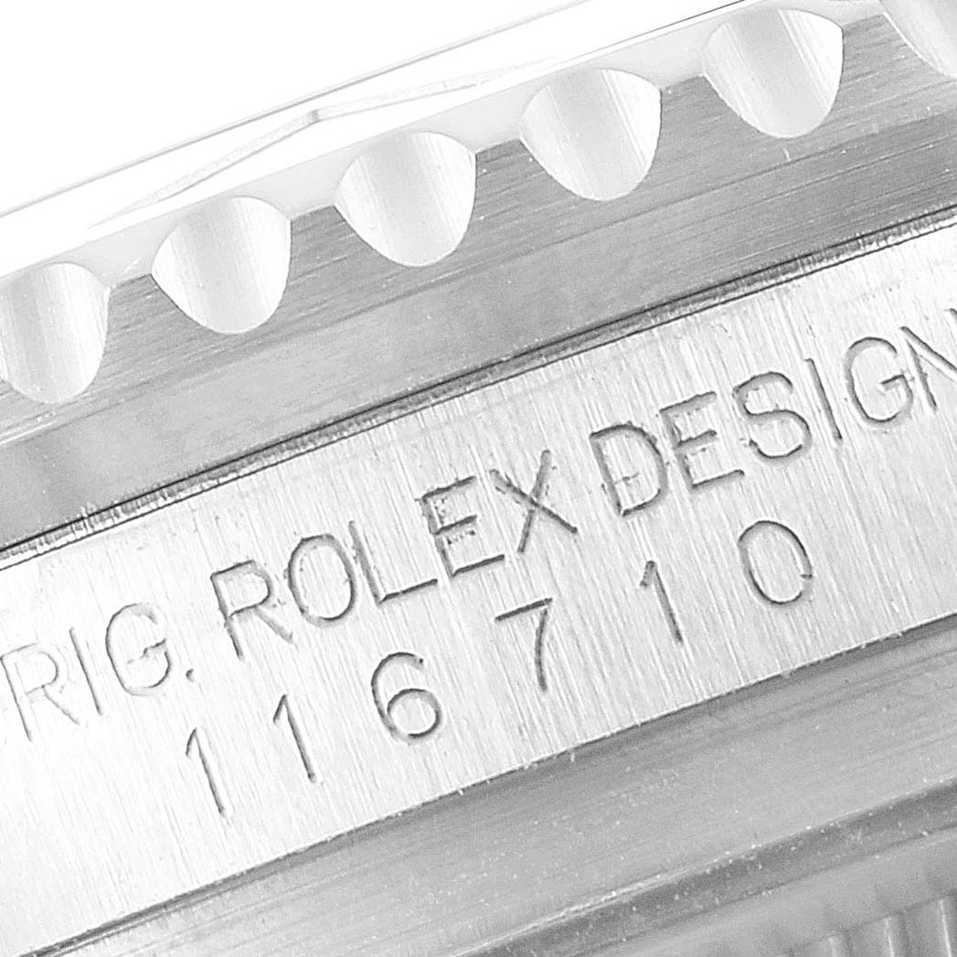 The image shows a close-up of the case side engraving and bezel edge of a Rolex GMT-Master 116710 Men
s Stainless Steel Black Dial 116710 Men
s Stainless Steel Black Dial model.