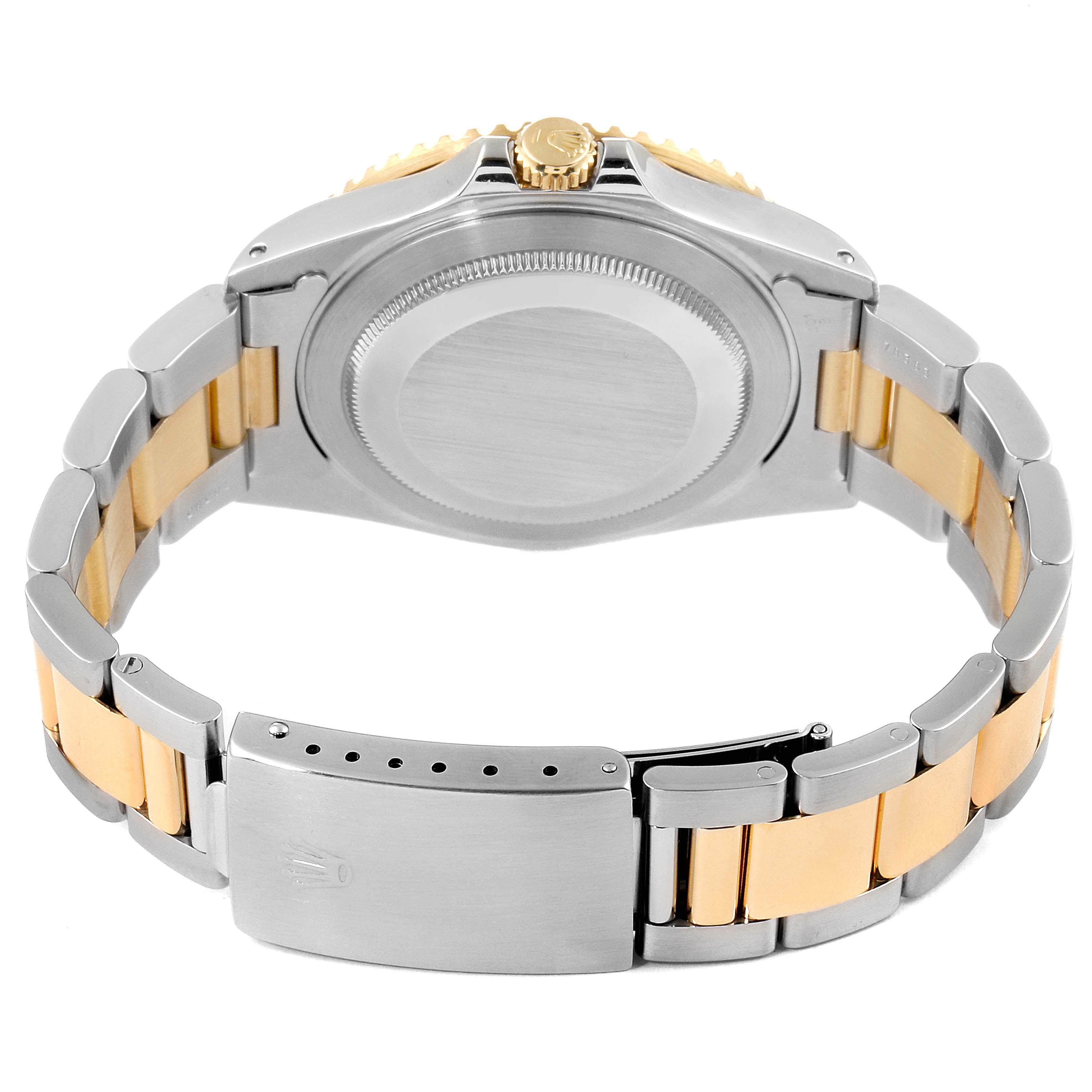 This image shows the back of the case and the bracelet of a Rolex GMT-Master 16713 Men's Steel and Gold (two tone) Black Dial 16713 Men's Steel and Gold (two tone) Black Dial watch, focusing on the clasp and crown.