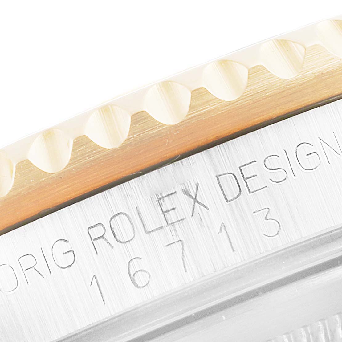 This image shows a close-up of the bezel and model number engraving on a Rolex GMT-Master 16713 Men's Steel and Gold (two tone) Black Dial 16713 Men's Steel and Gold (two tone) Black Dial watch.